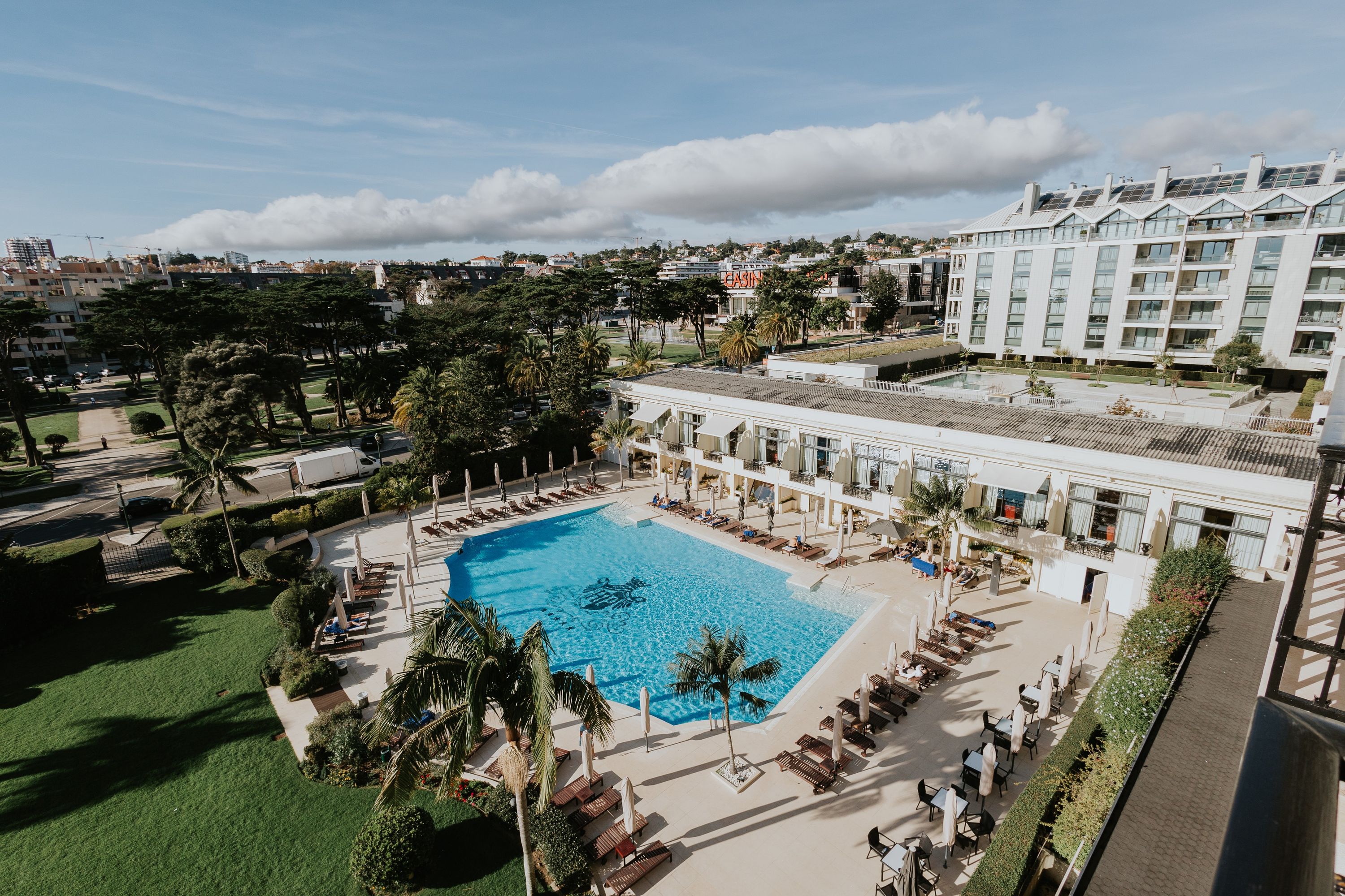 Classic white palace hotel with gardens and a pool in Cascais for destination weddings in Portugal