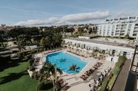 Classic white palace hotel with gardens and a pool in Cascais for destination weddings in Portugal