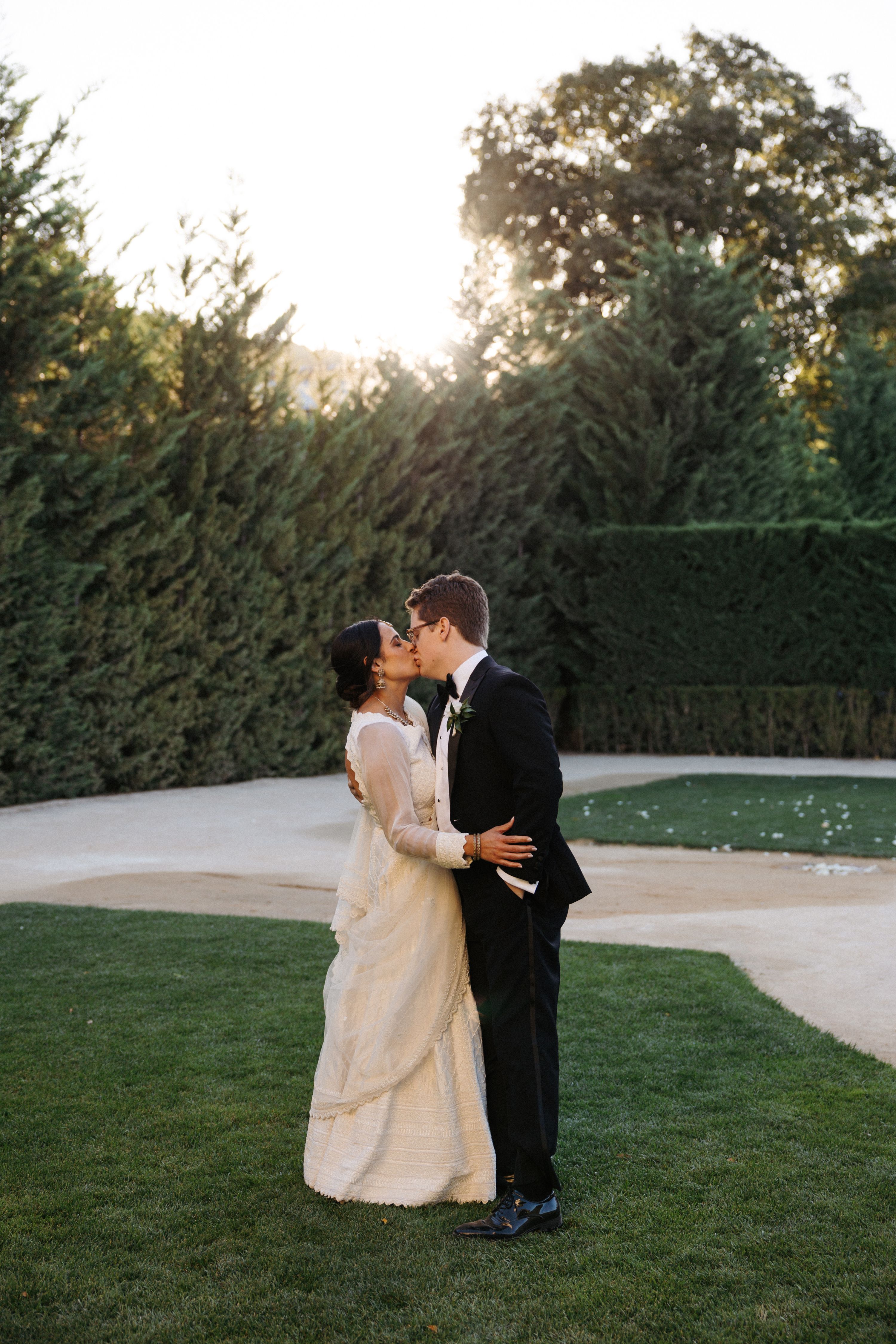 Bride and groom sharing a sunset kiss after an intimate wedding in Portugal