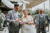 Bride and groom happily signing a paper during the ceremony of their destination wedding in Portugal