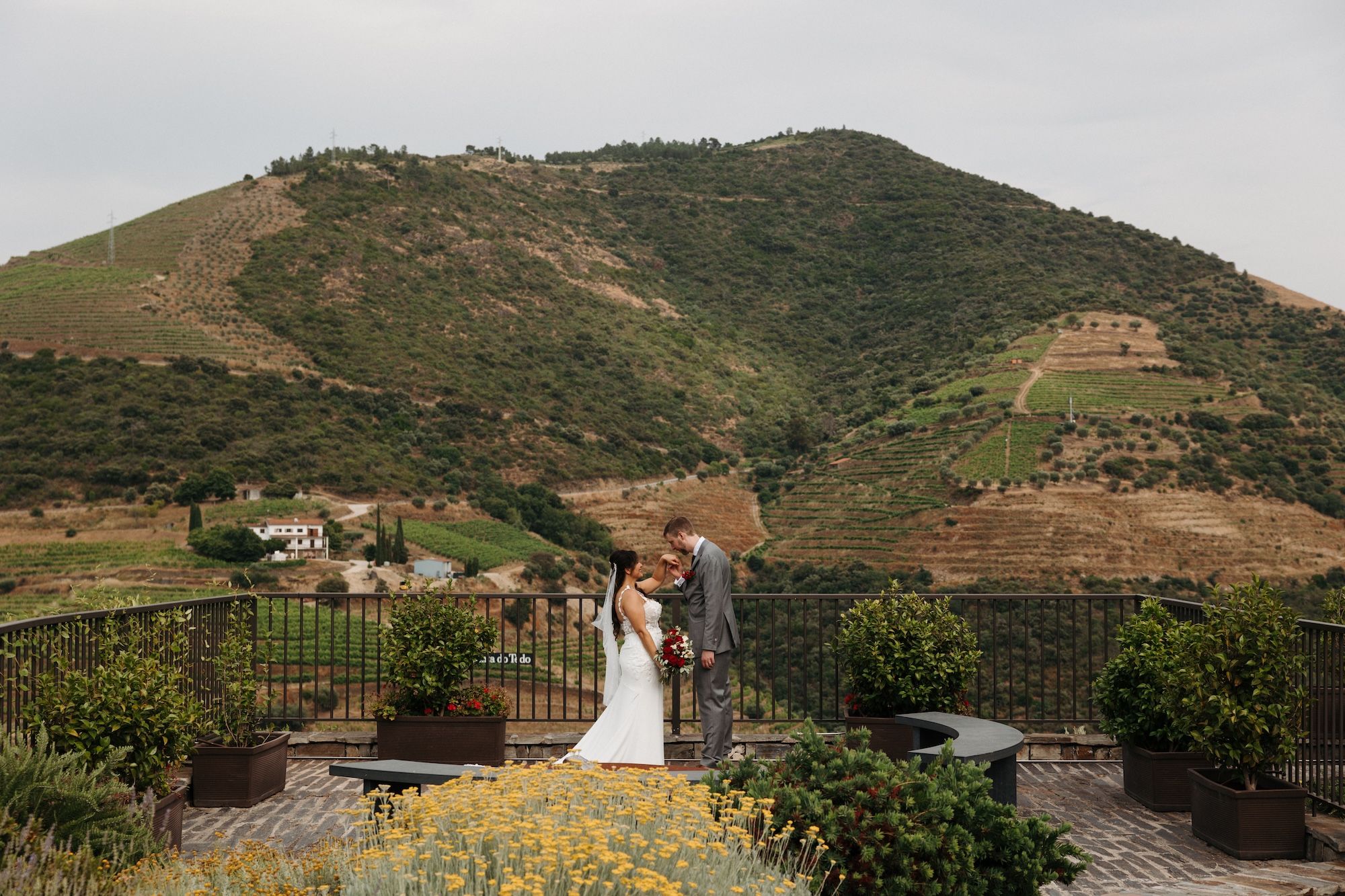 Newlyweds having a romantic photoshoot for their small wedding in Portugal with mountains and vineyards in the background