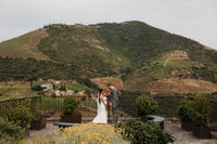 Newlyweds having a romantic photoshoot for their small wedding in Portugal with mountains and vineyards in the background