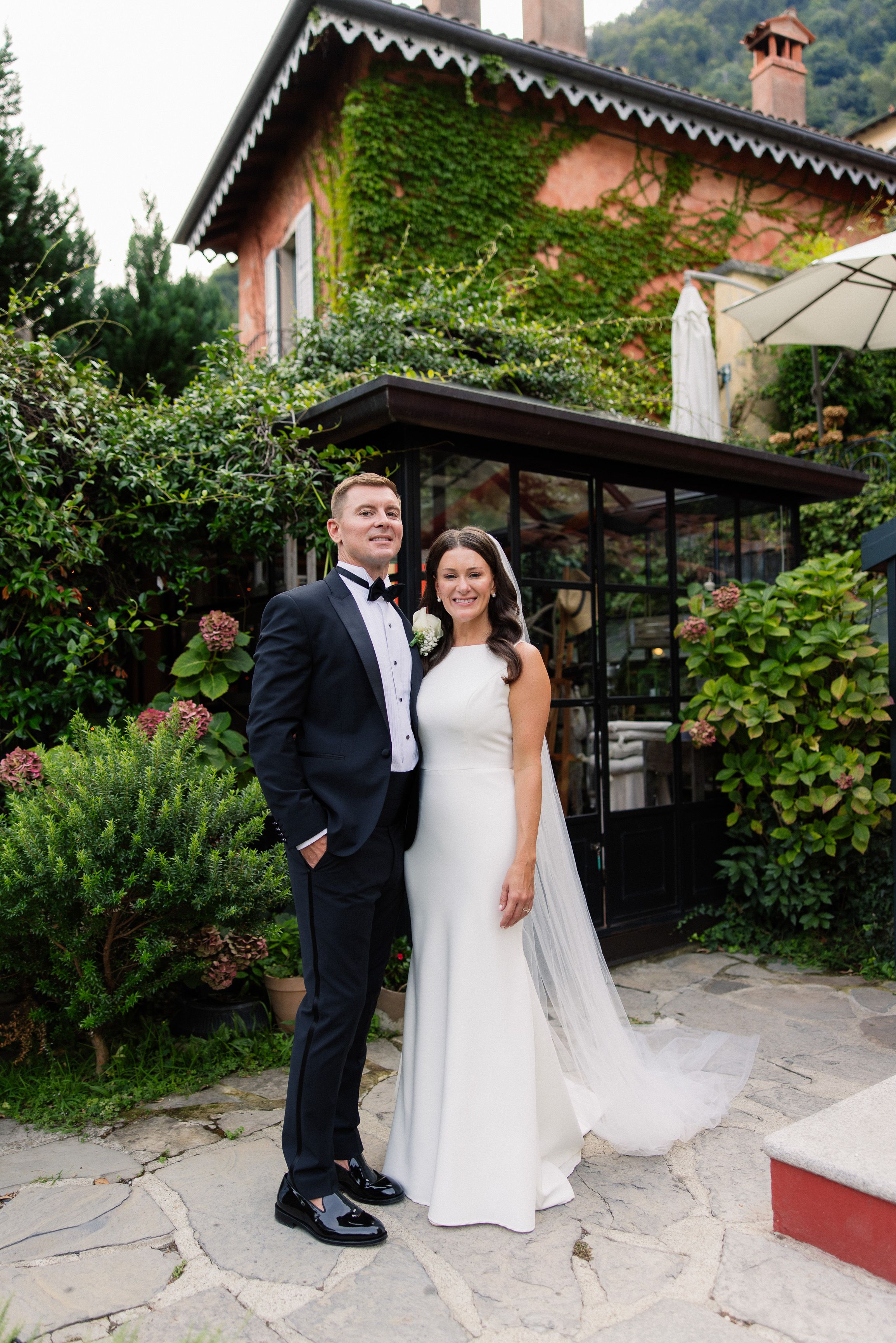 Newlywed couple posing outside a charming villa during an intimate wedding in Italy