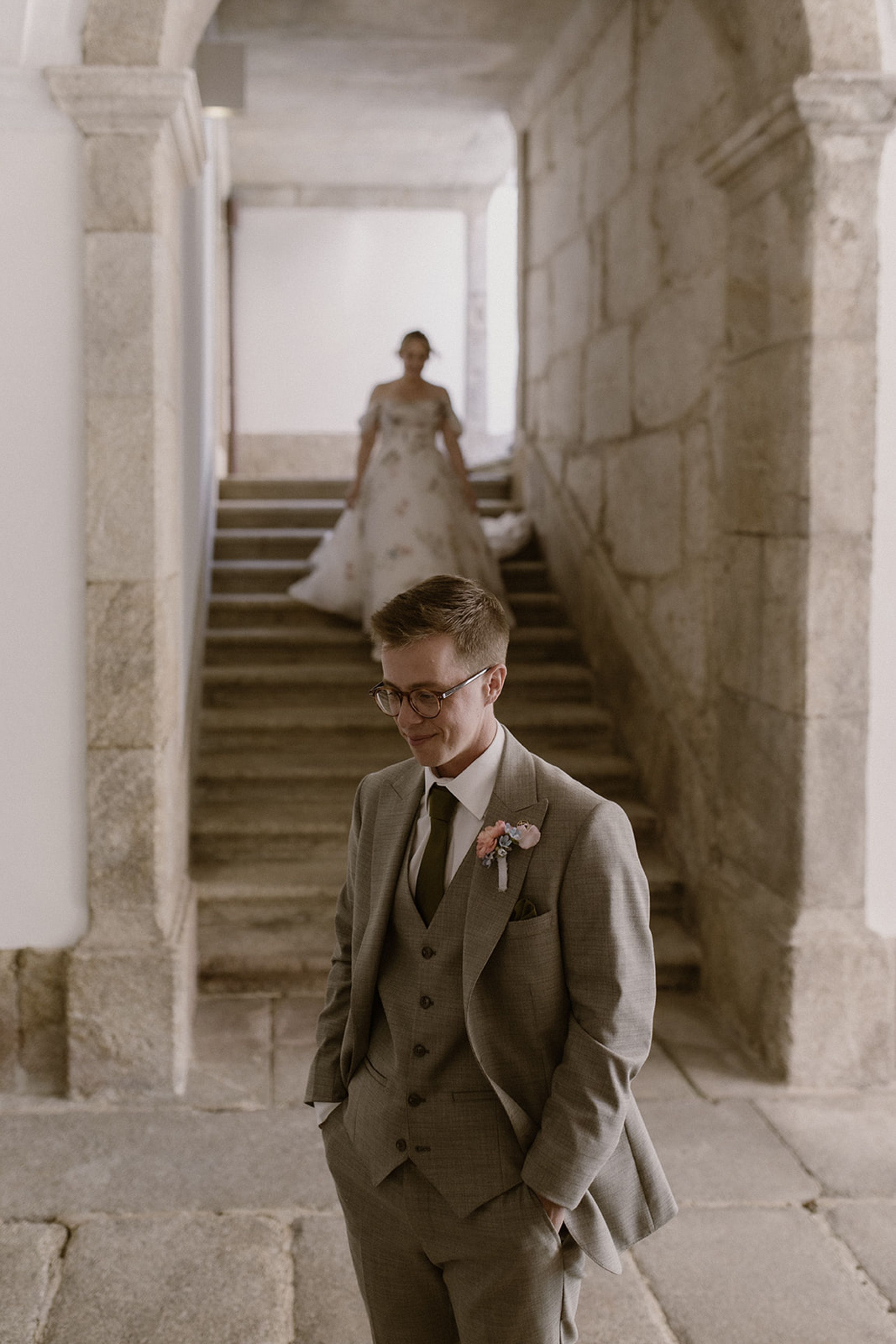 Groom smiling before the first look as the bride approaches for an intimate wedding in Portugal