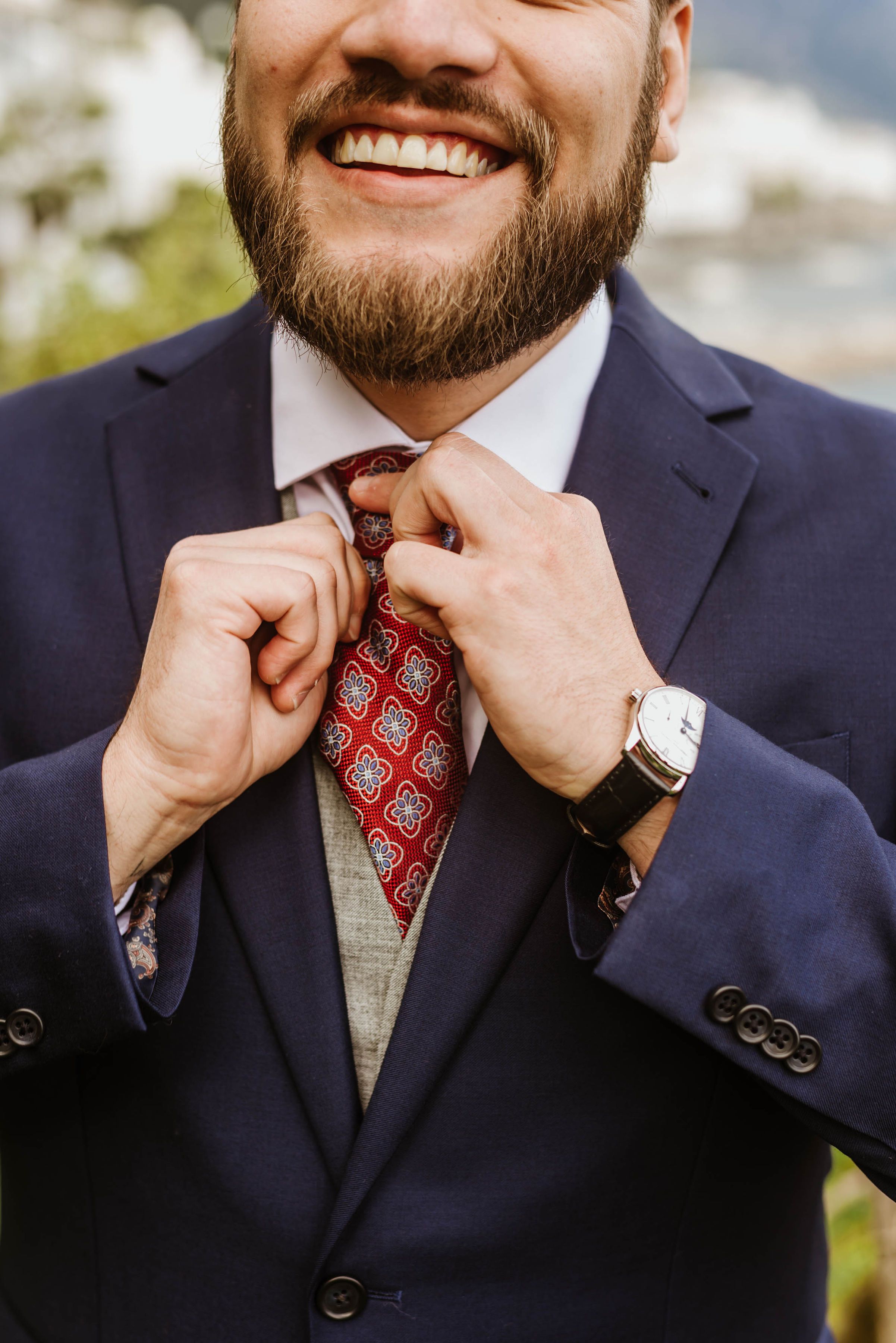 Groom adjusting his tie before a small wedding in Italy at an elegant countryside venue