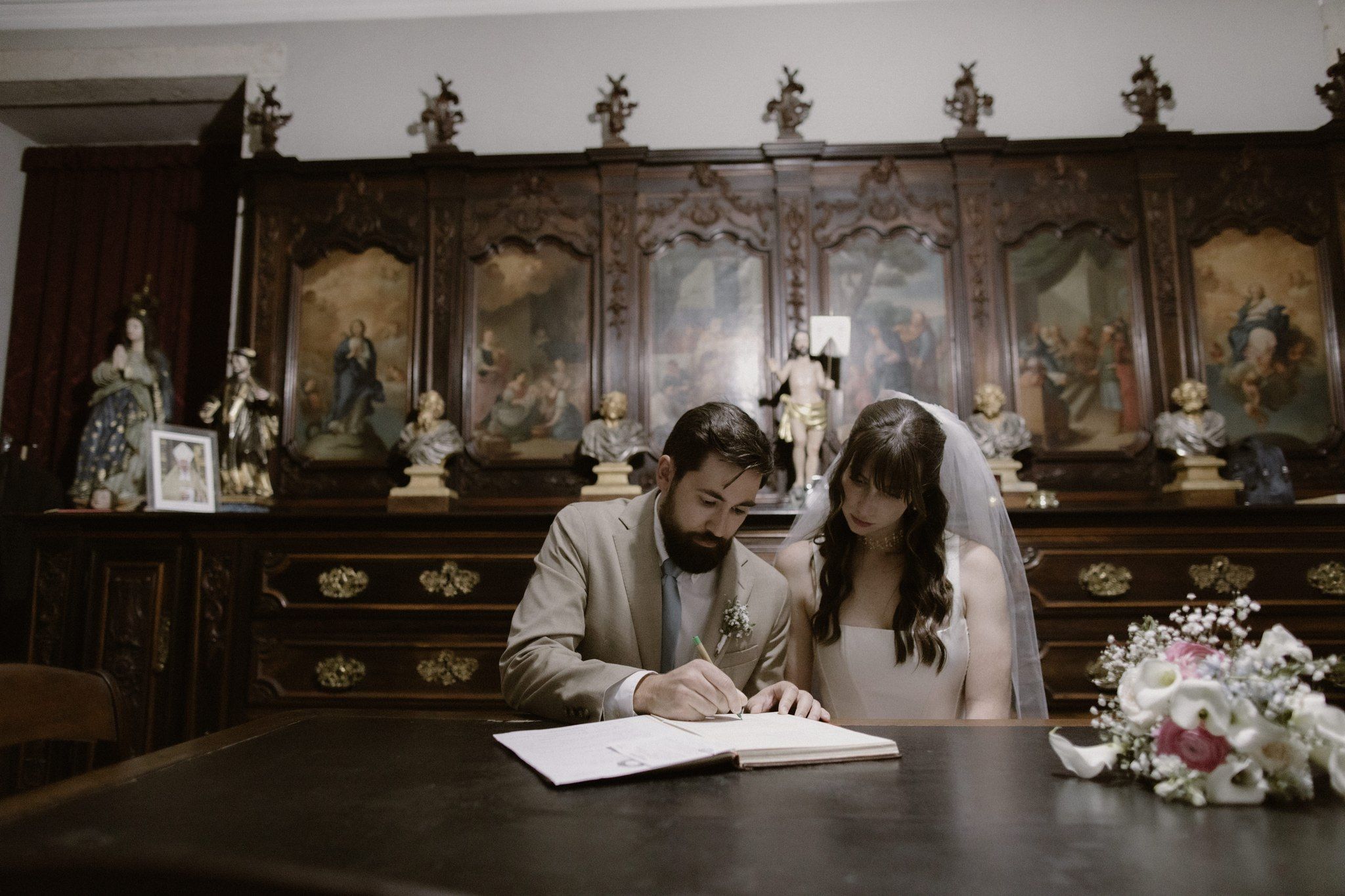 Couple signing their marriage certificate at their legally-binding church wedding in Portugal