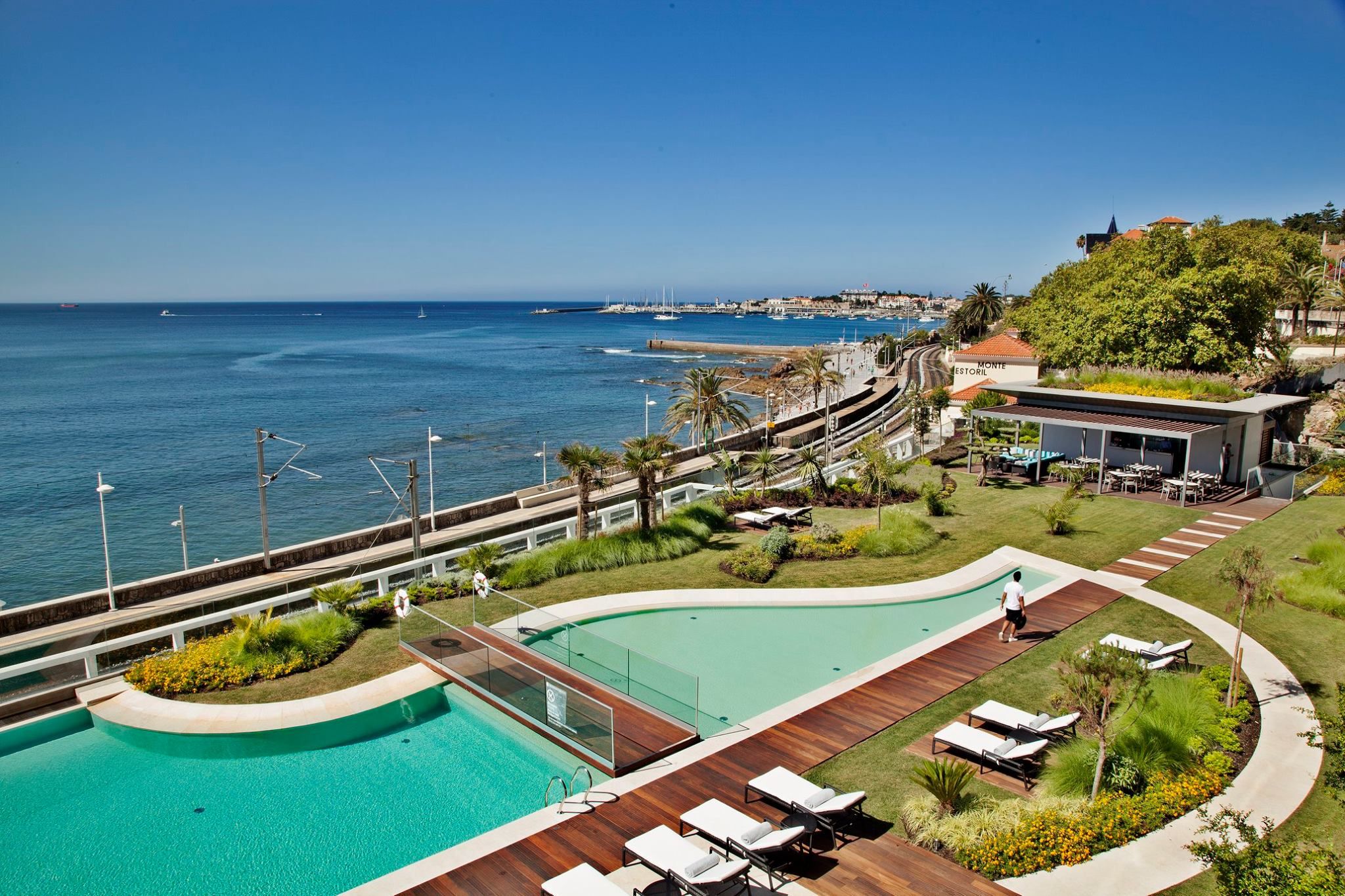 A modern 5-star hotel with a large pool facing the Estoril coast for destination weddings in Portugal