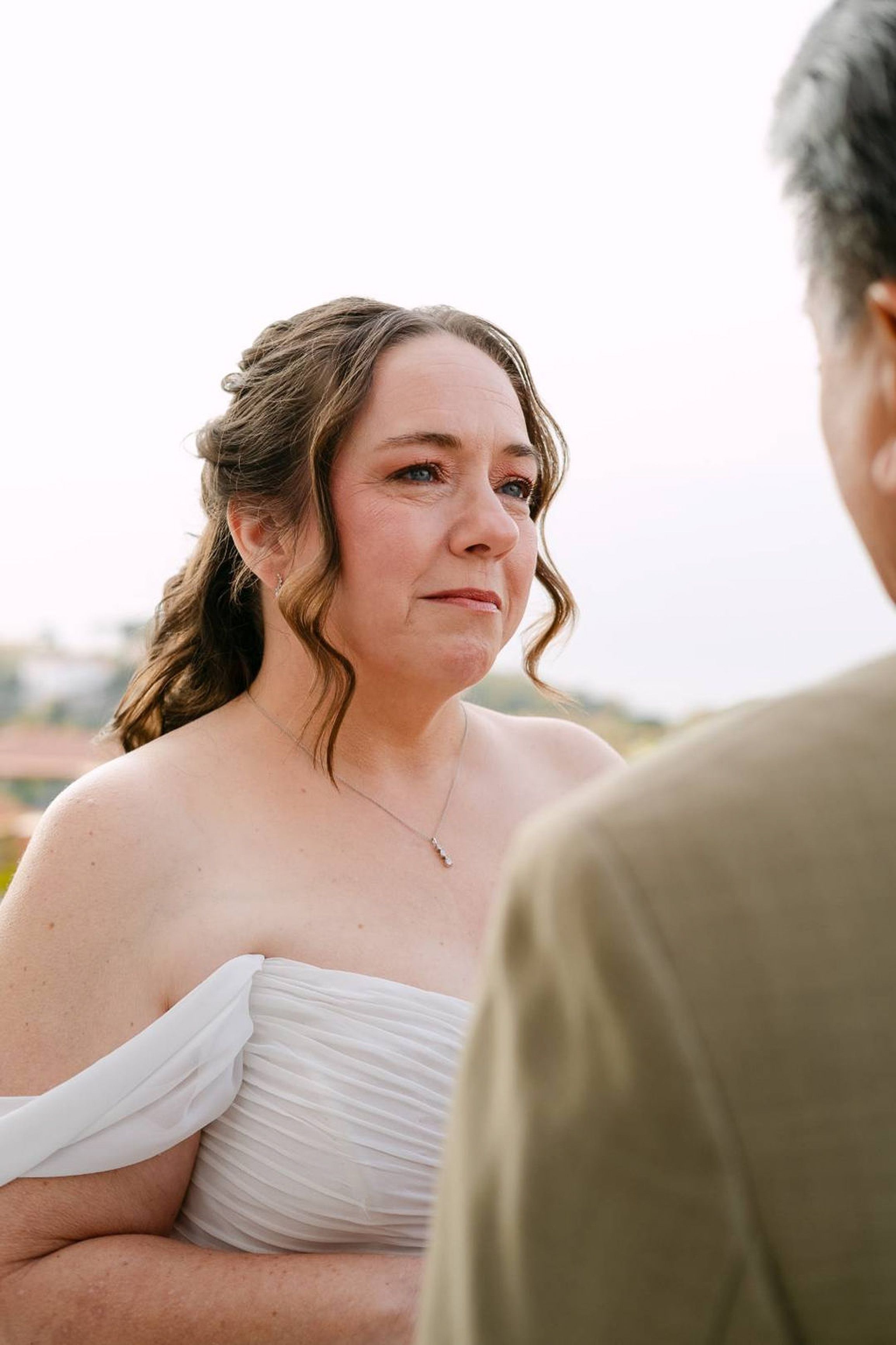 Bride listens closely during personal vows at an intimate wedding in Italy