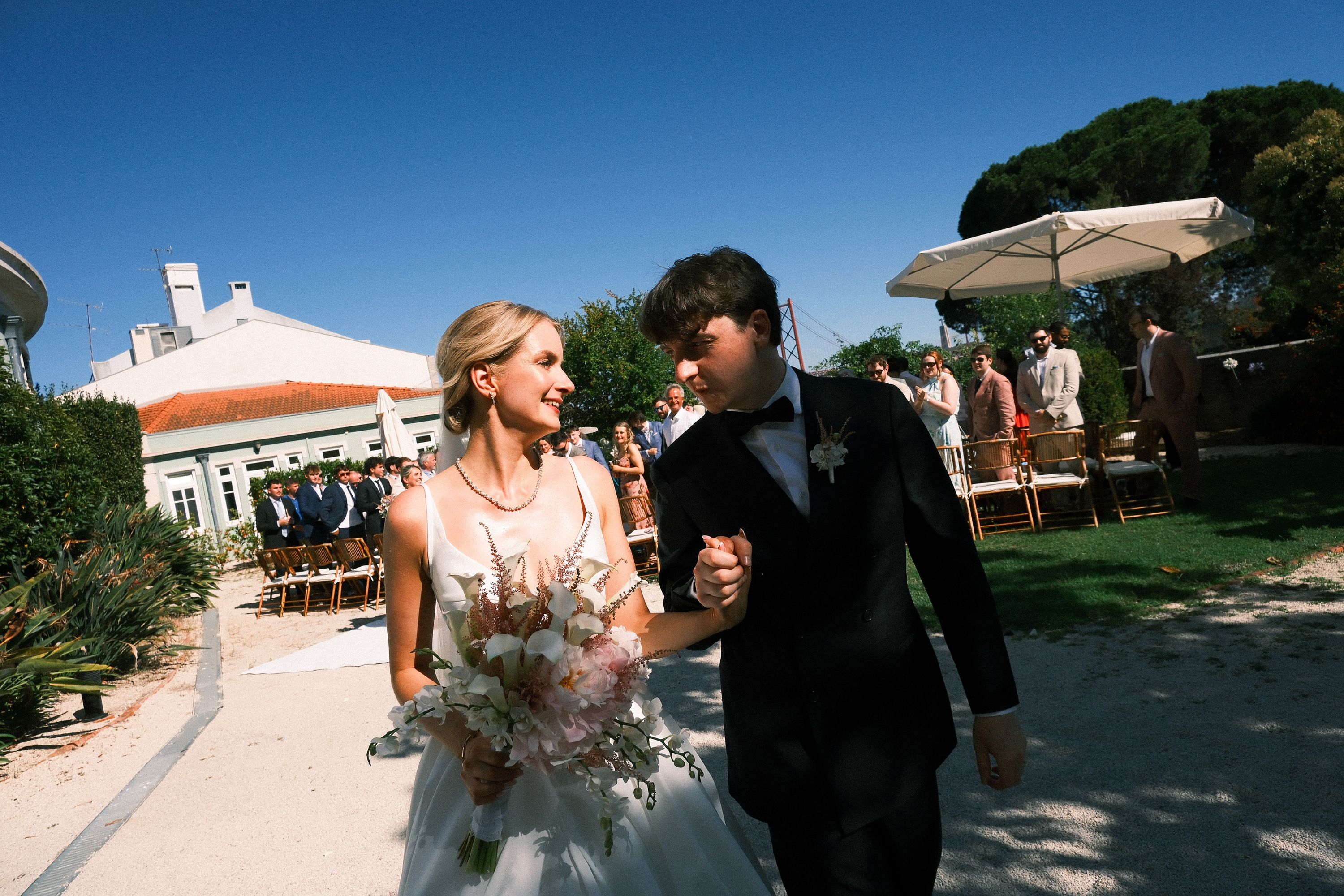 Newlyweds walk hand in hand after their intimate wedding in Portugal ceremony