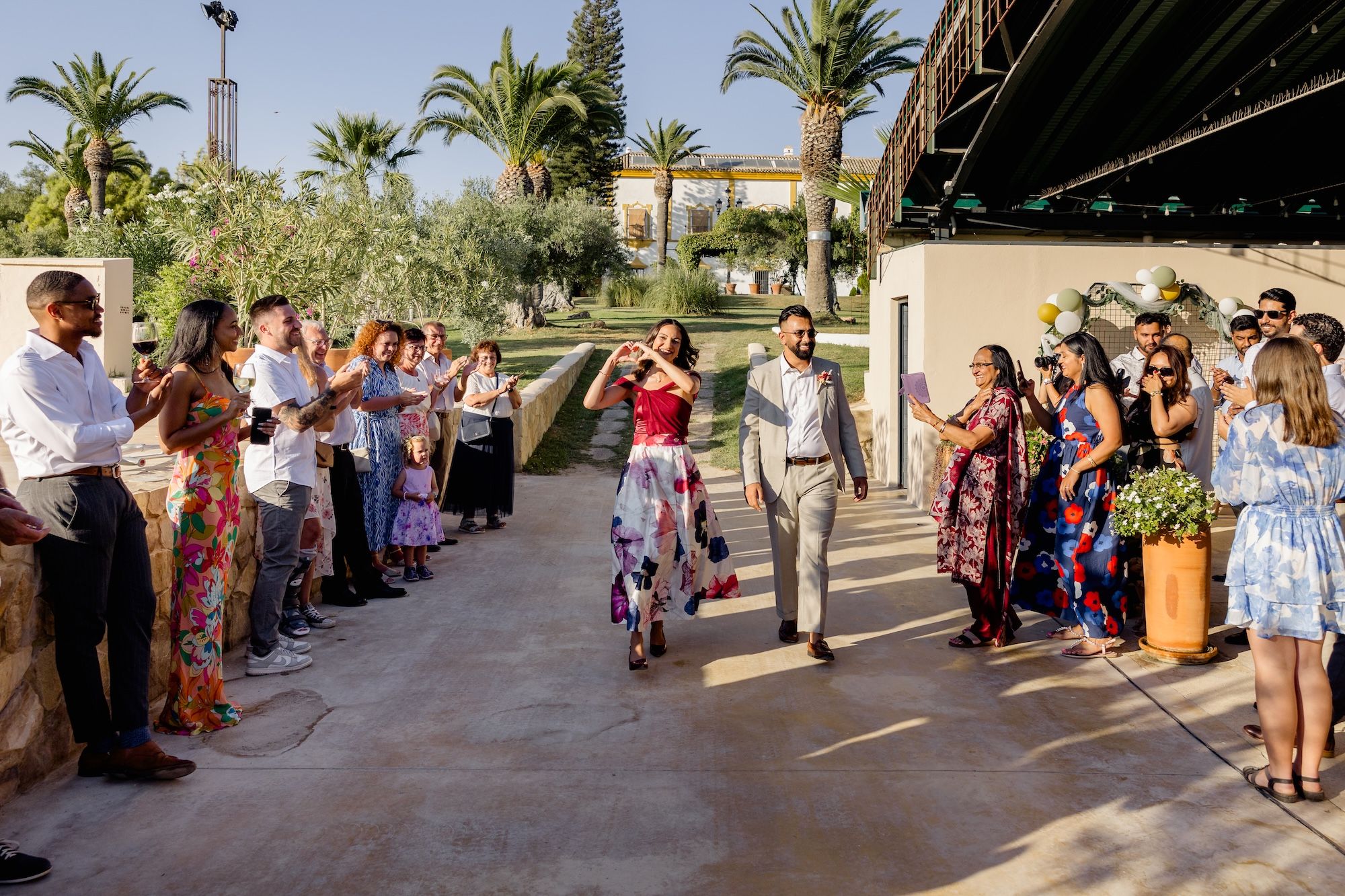 Newlyweds arrive at the outdoor spot for dancing after the ceremony of their small wedding in Spain