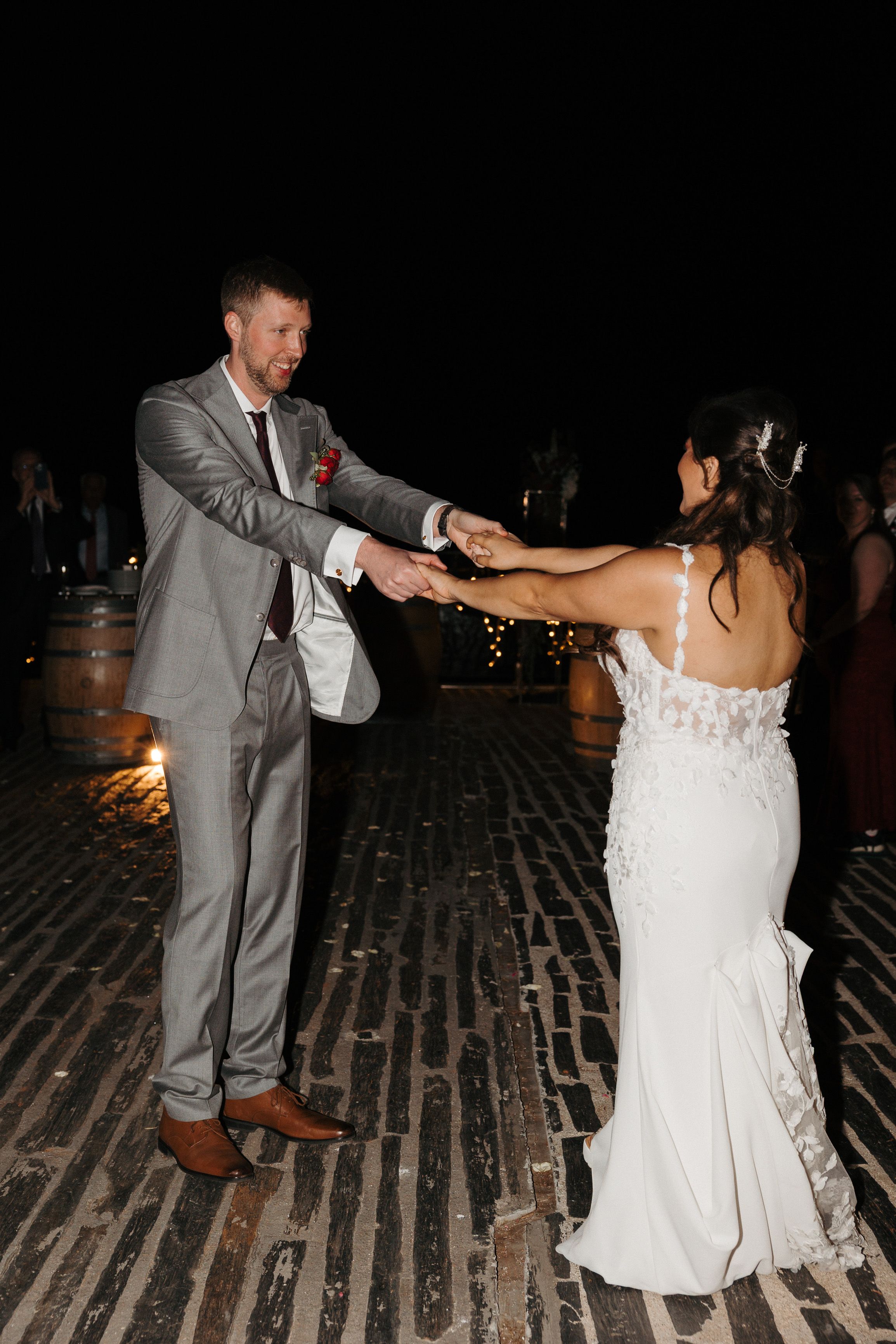 Newlyweds twirling during their first dance at an intimate wedding in Portugal reception