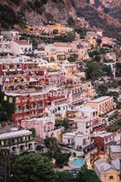Pastel-colored hotels cascading down the coast in Amalfi, Italy