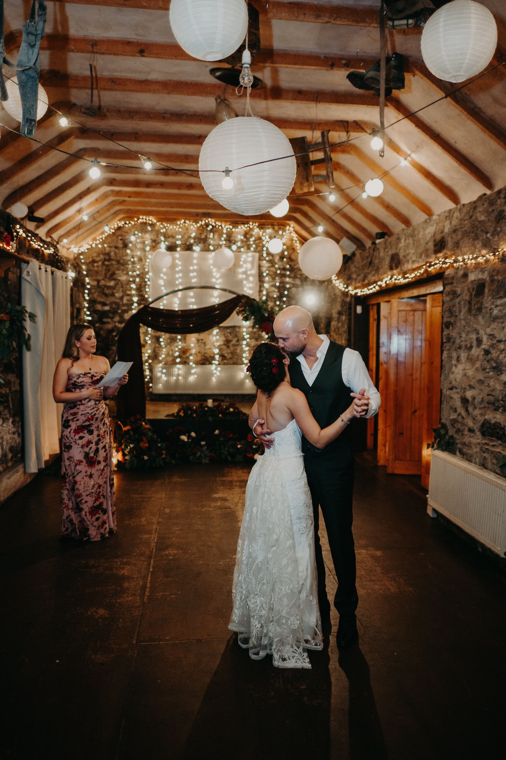 Groom kisses his bride on the forehead as they danced inside the Irish pub during the reception of their small wedding in Ireland