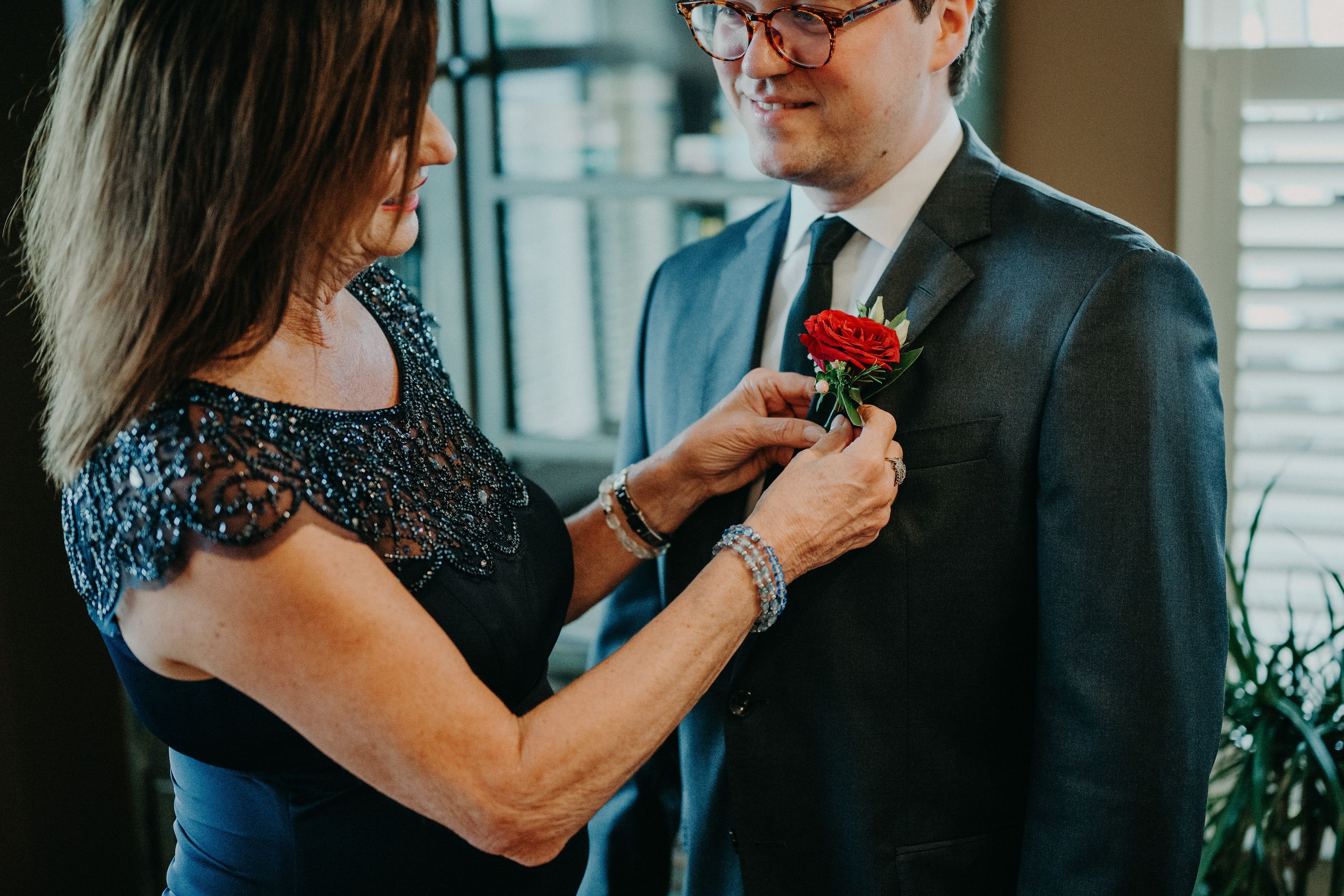 Mother adjusting the groom’s boutonniere before an intimate wedding in Ireland