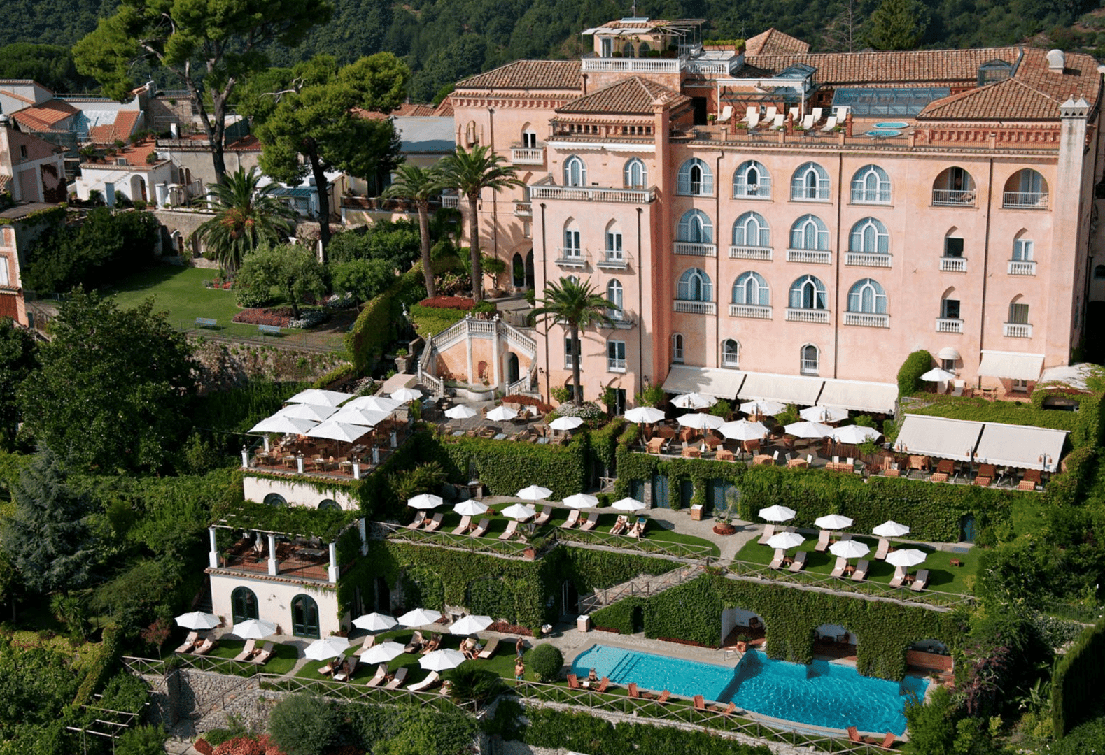5-star deluxe pink hotel with sunshades and infinity pools in Ravello