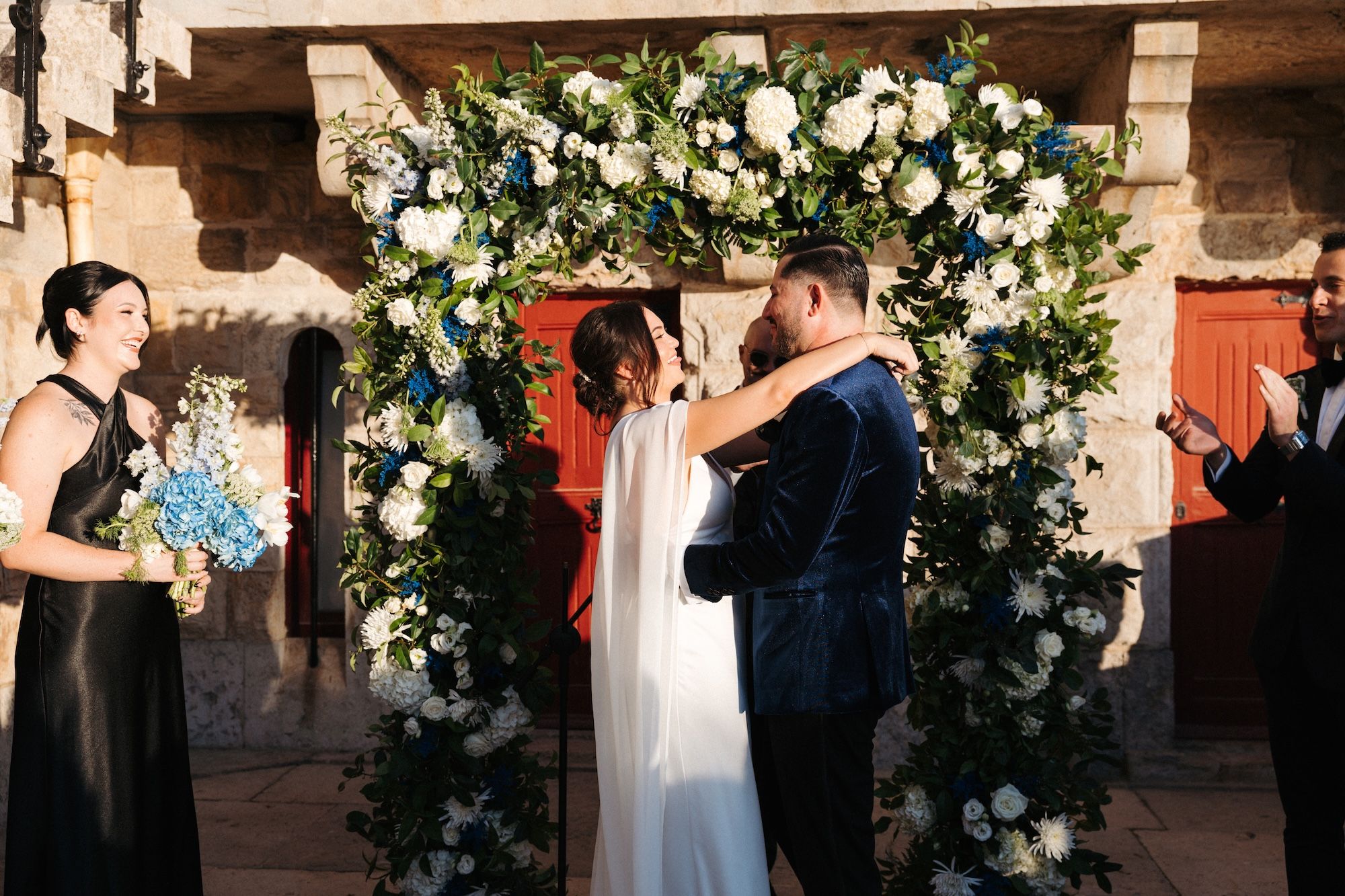 Bride and groom kissing under the sunset during the ceremony of their intimate wedding in Portugal