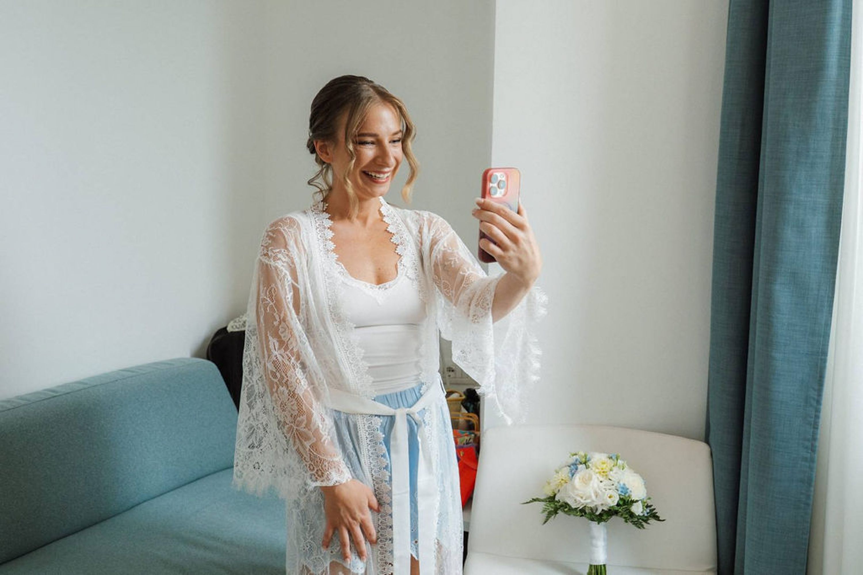 Bride smiling during a video call while getting ready for a small wedding in Europe