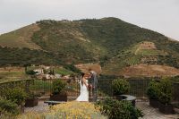 Bride and groom sharing an intimate moment on terrace overlooking Douro Valley during their destination wedding in Portugal