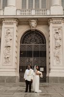Newlyweds having a photoshoot outside the museum where they got married in Italy