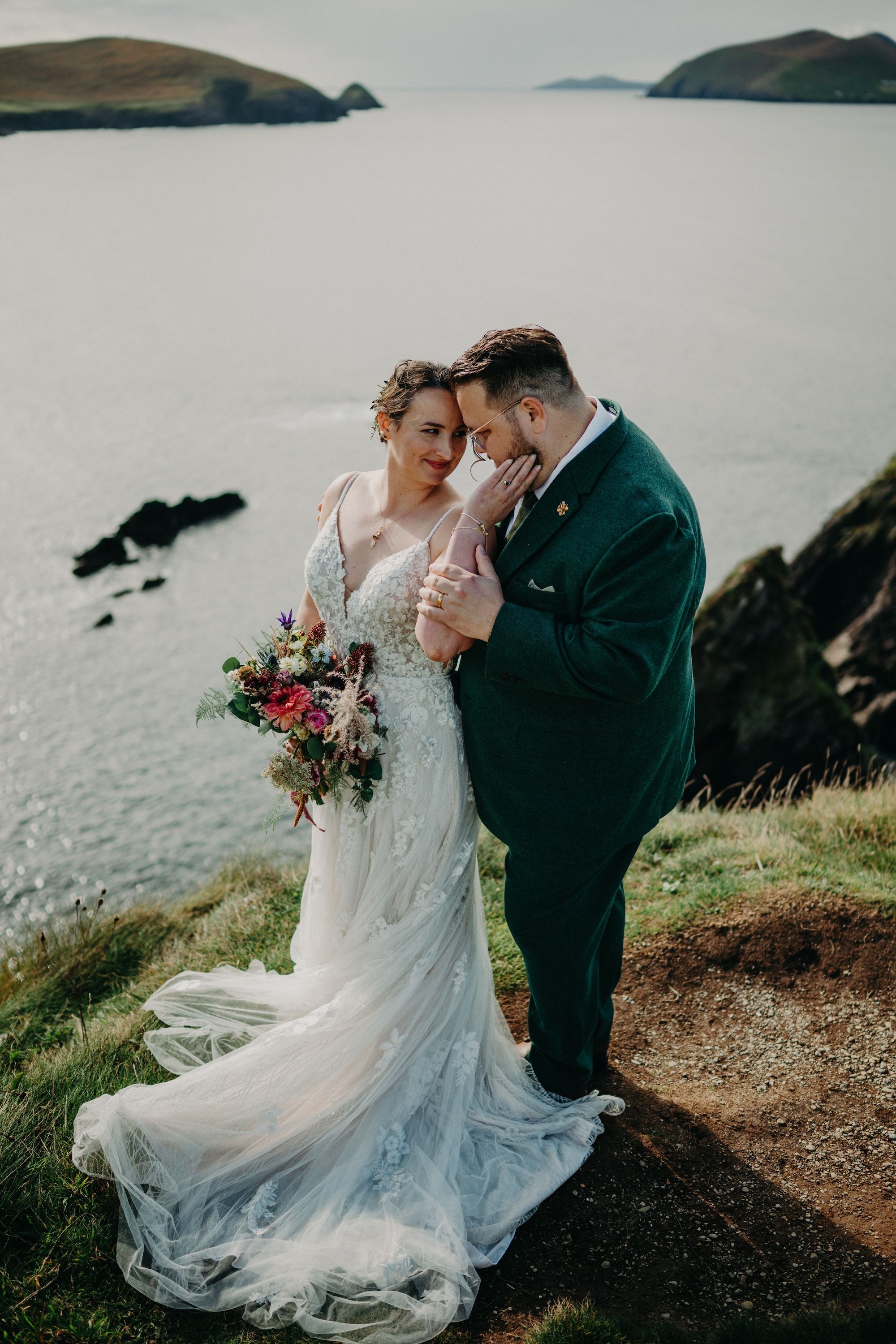 Newlyweds having a romantic photoshoot at the top of the cliffs of Kerry during their elopement in Ireland