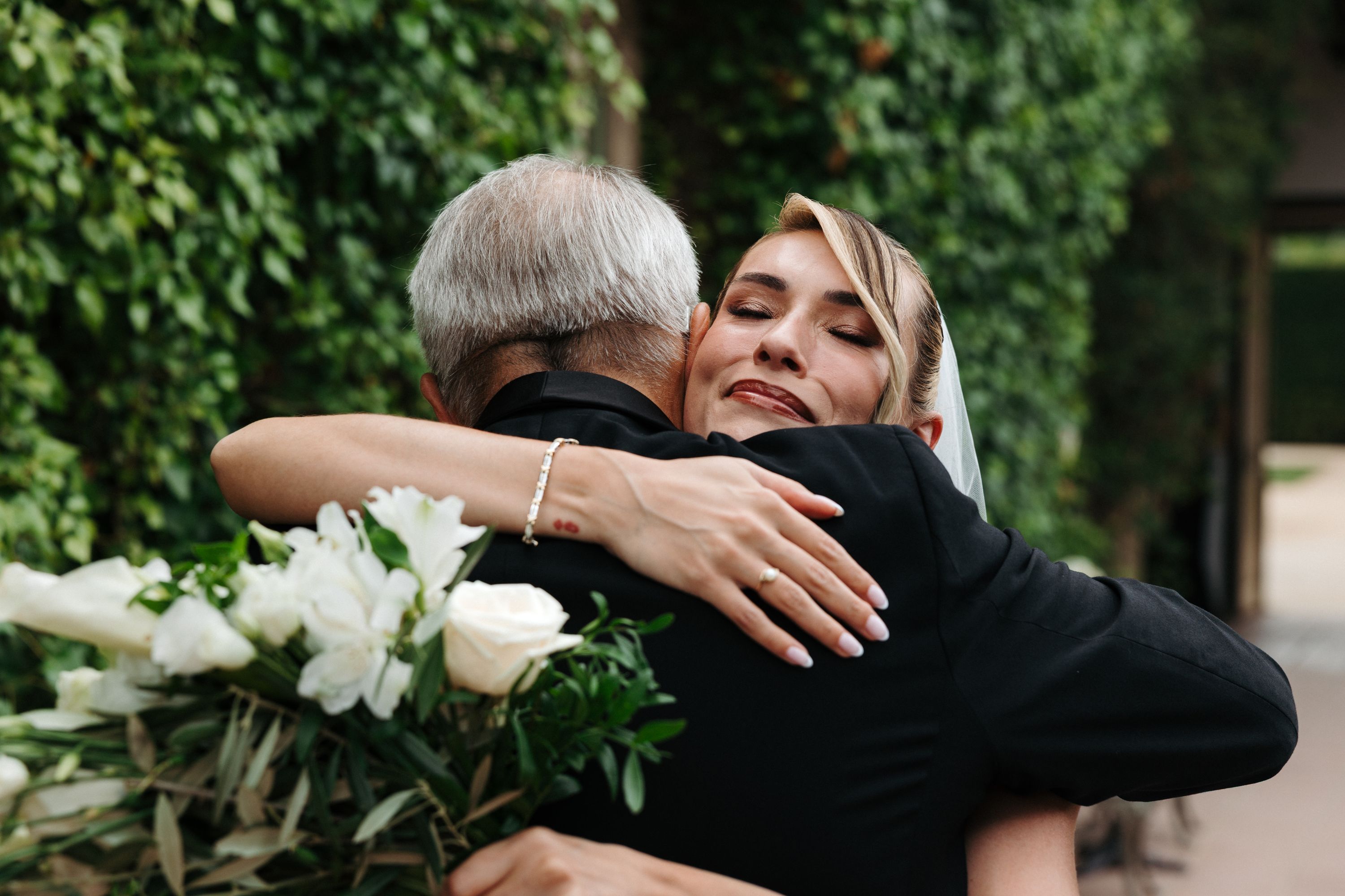 Father and daughter hugging on the day of her wedding in Portugal