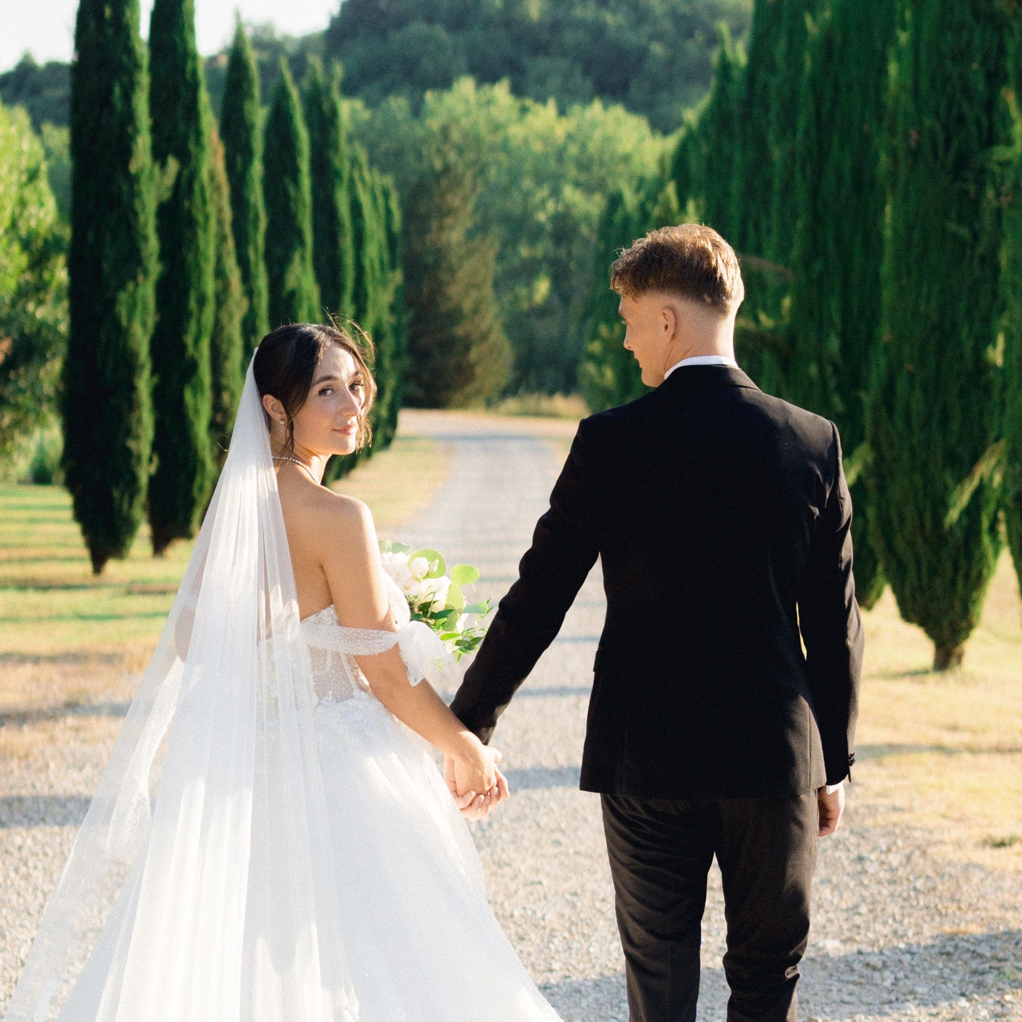 Bride and groom holding hands on their wedding day in Italy