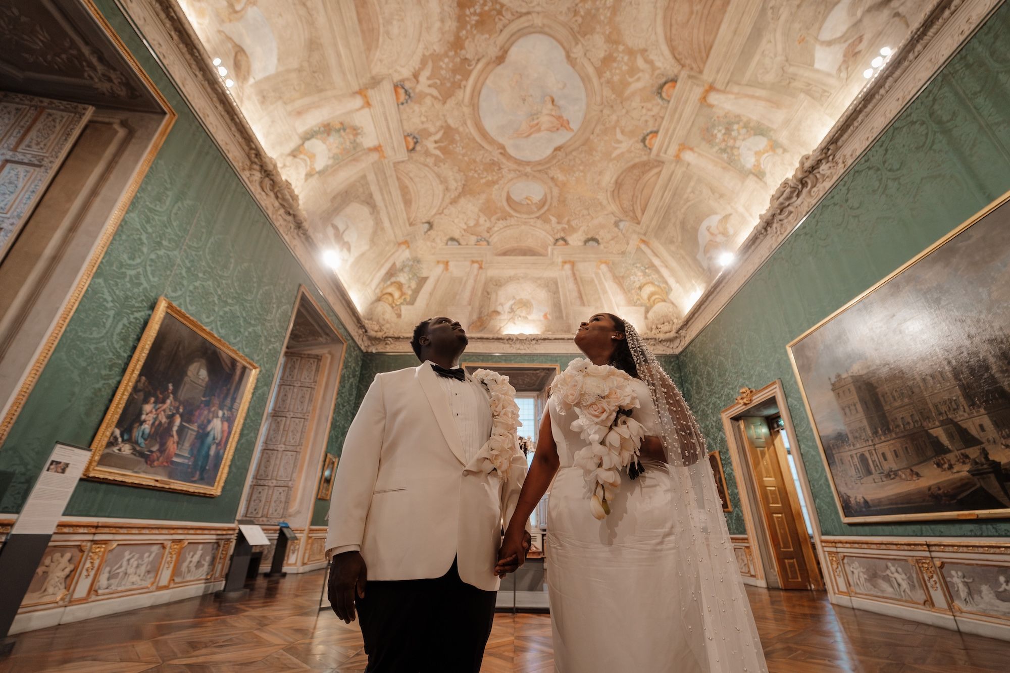 Bride and groom looking at the ceiling of a museum where they had an elopement in Italy