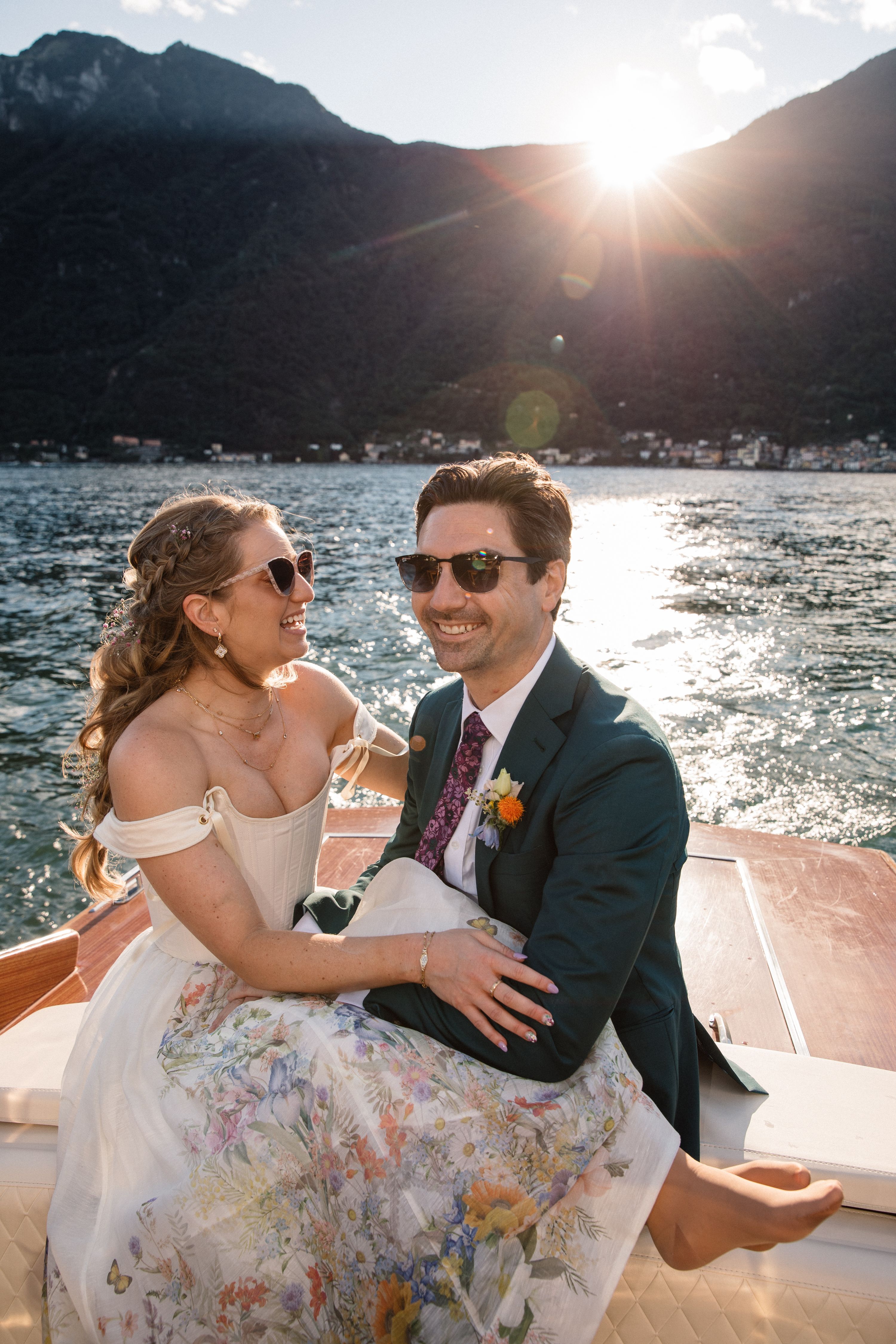 Bride looks at her groom as they ride a boat that sails above Lake Como for their elopement in Italy