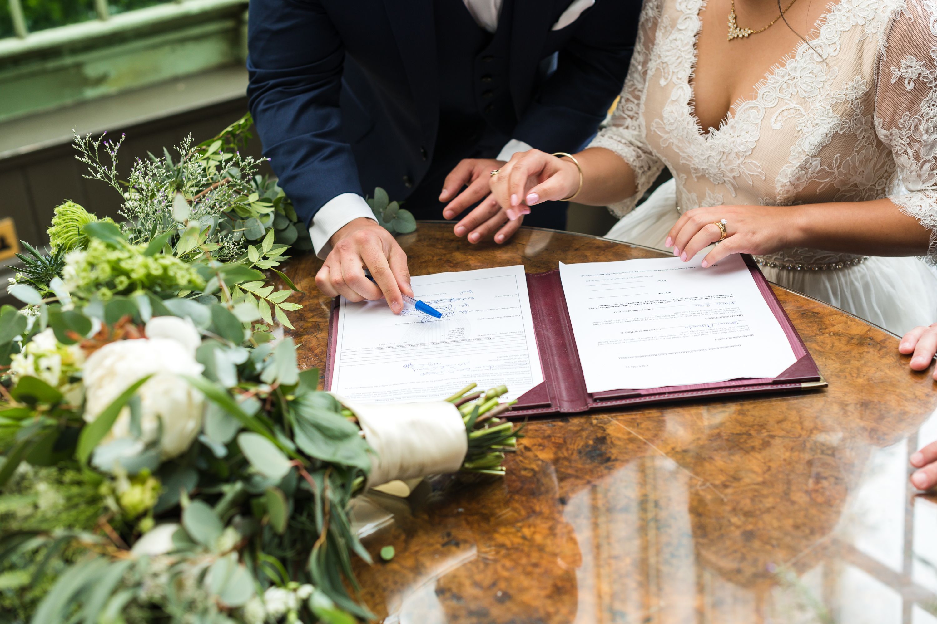Bride and groom signing the marriage paperwork at their civil wedding in Ireland