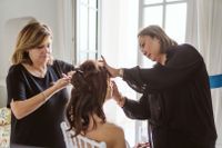 Bride getting her makeup done for her destination wedding in Italy, with two makeup artists with her