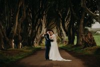 Bride and groom having a photoshoot in an iconic nature spot in the Dark Hedges when they got married in Ireland