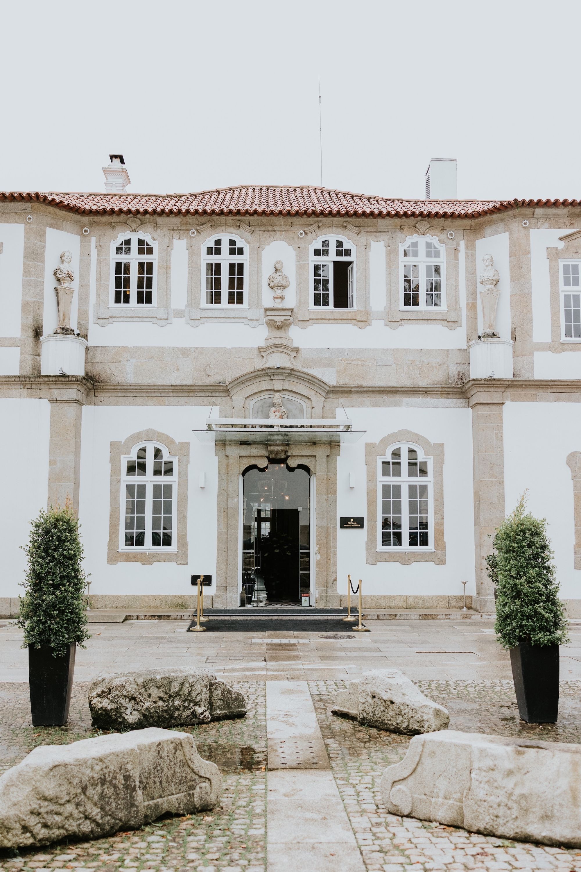 Facade of a white palace hotel in Porto where our couple had a micro wedding in Portugal
