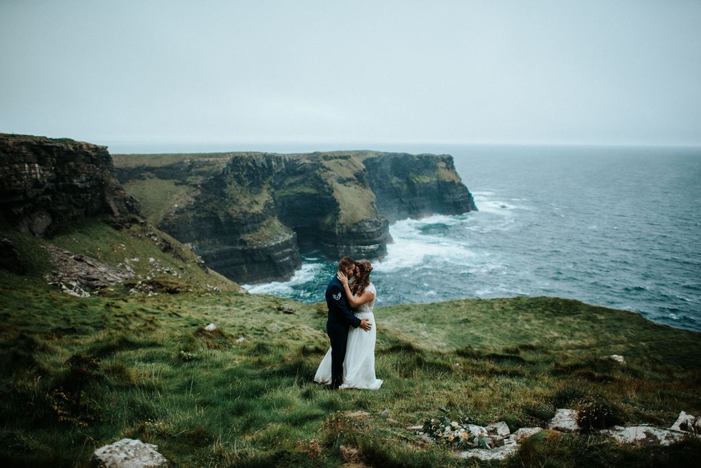 Newlyweds at Hags Head with the wild Atlantic Ocean and the cliffs of Ireland in the background