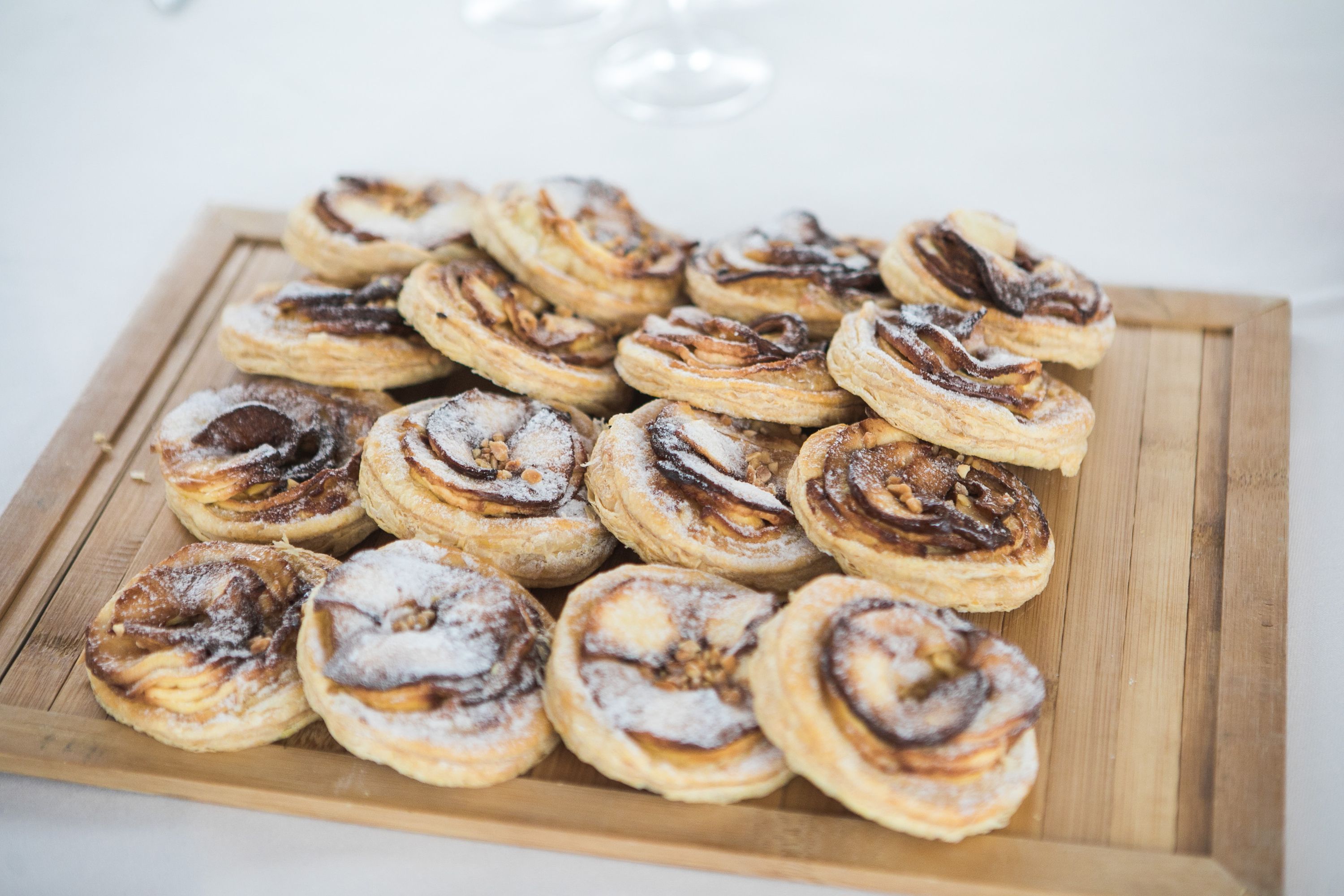 Fresh pastries displayed on a wooden board for guests at a small wedding in Portugal