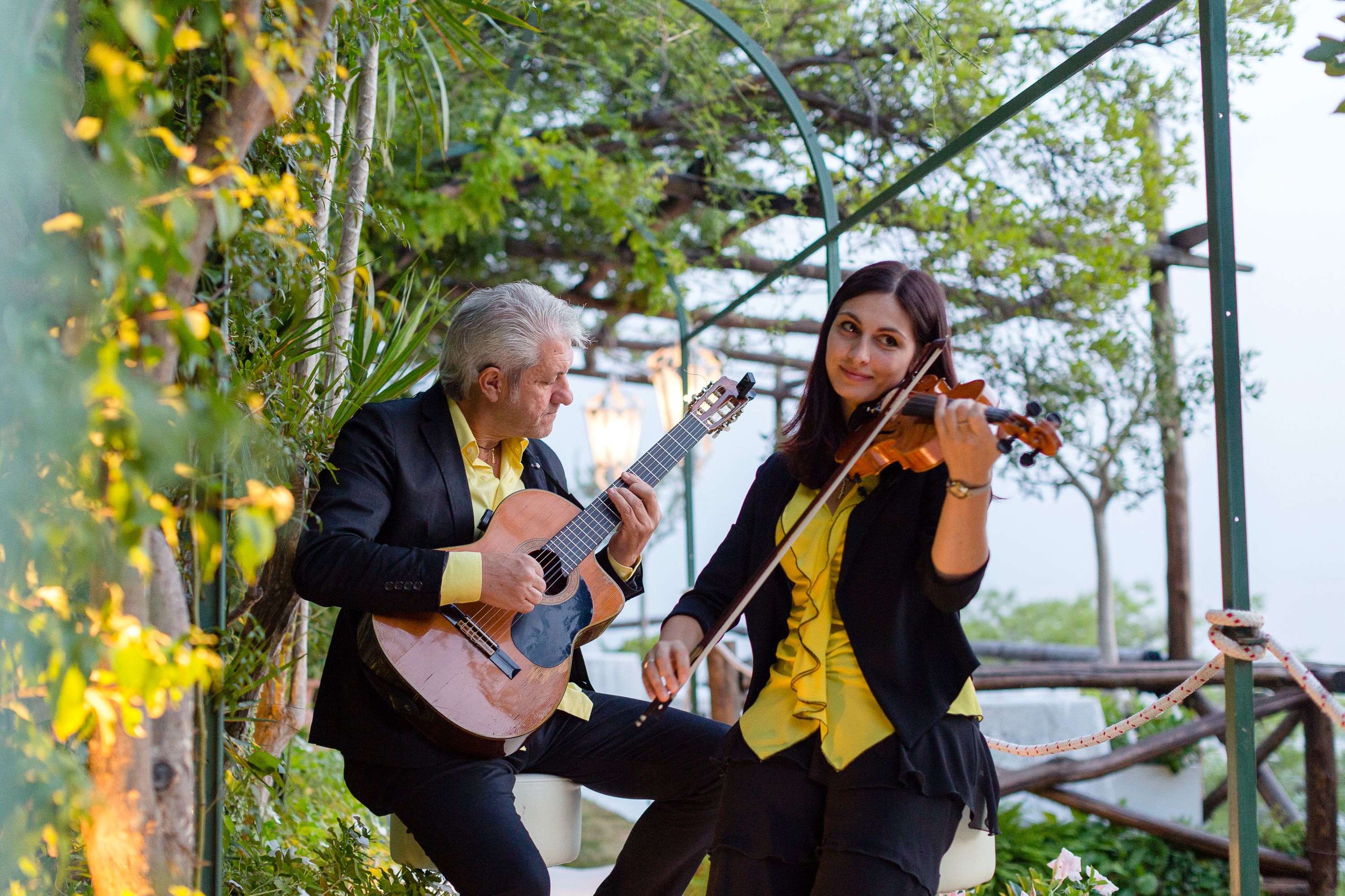A guitarist and violinist providing beautiful music for a small wedding in Italy