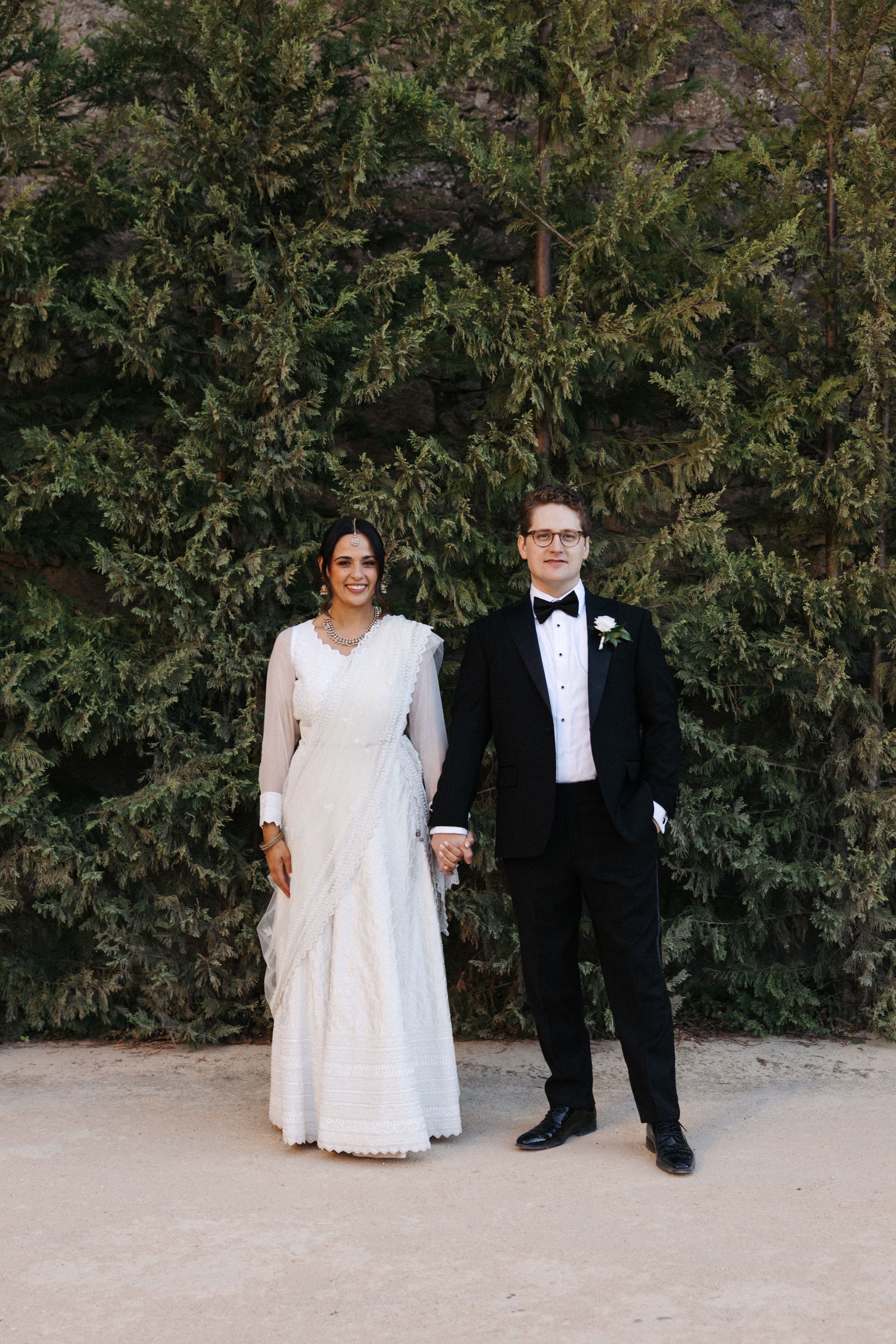 Bride and groom holding hands for a timeless portrait during a small wedding in Portugal