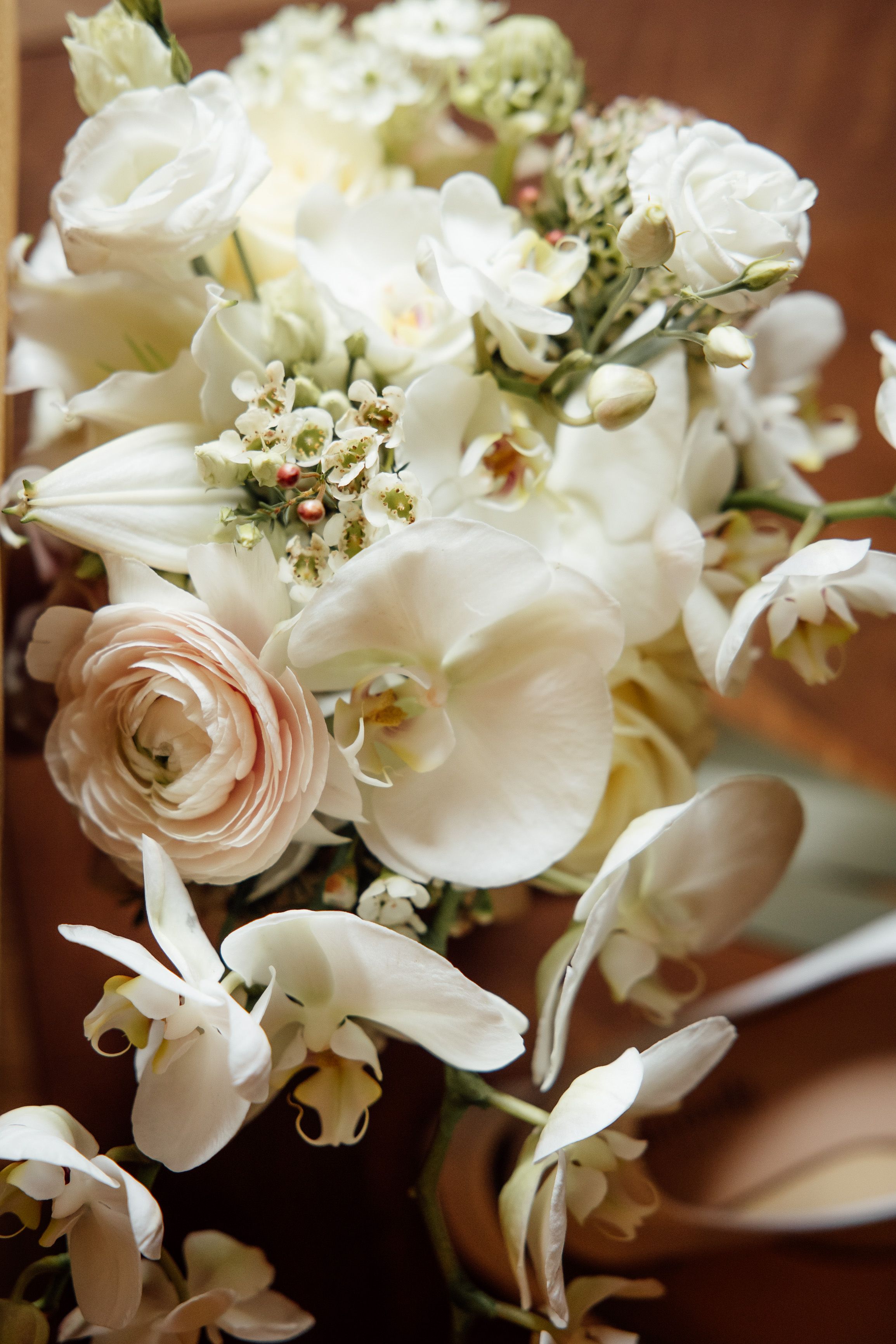 White orchid and rose bridal bouquet detail captured at an intimate wedding in Austria