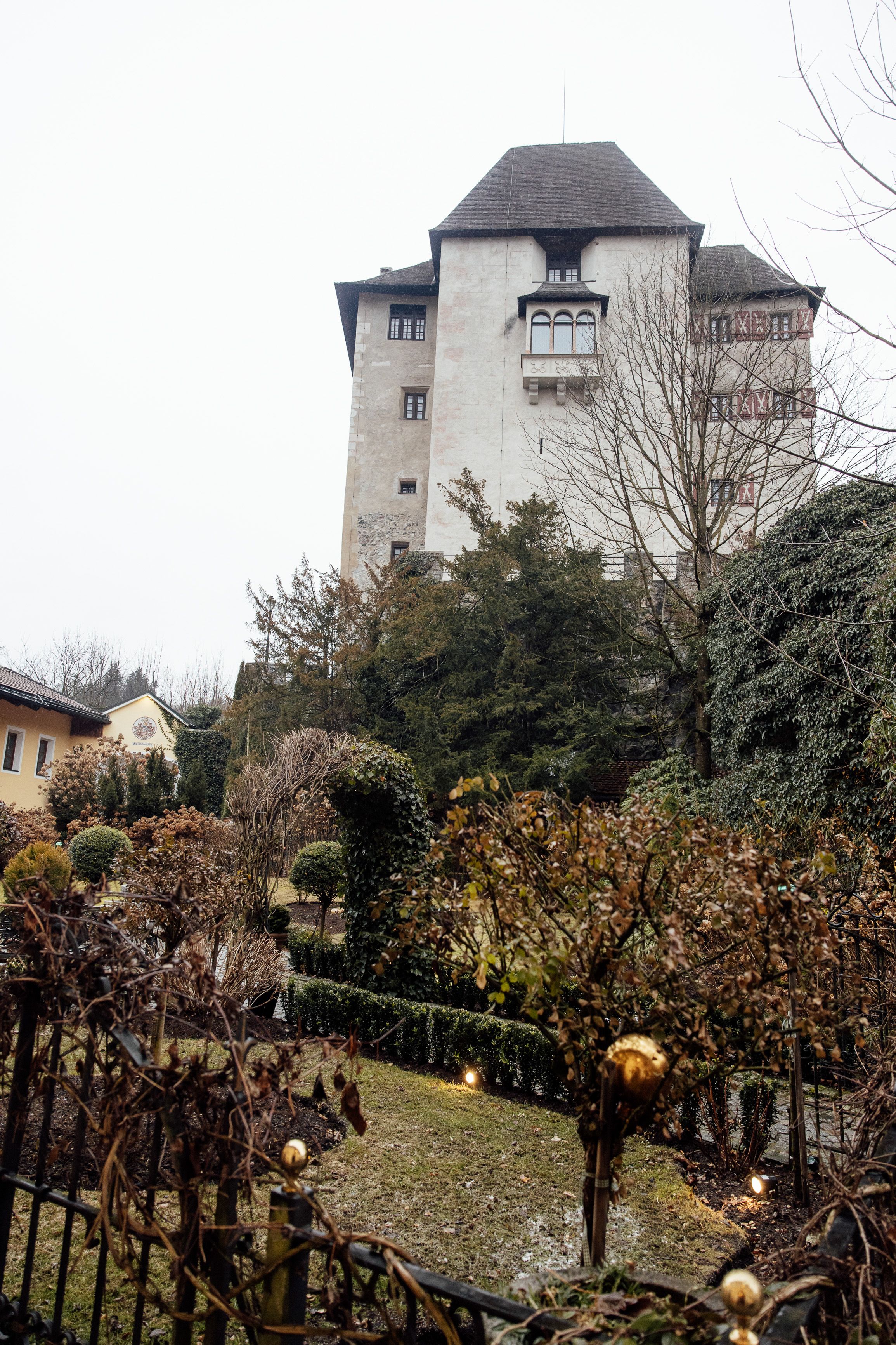 Castle and landscaped gardens create a picturesque backdrop for a small wedding in Austria