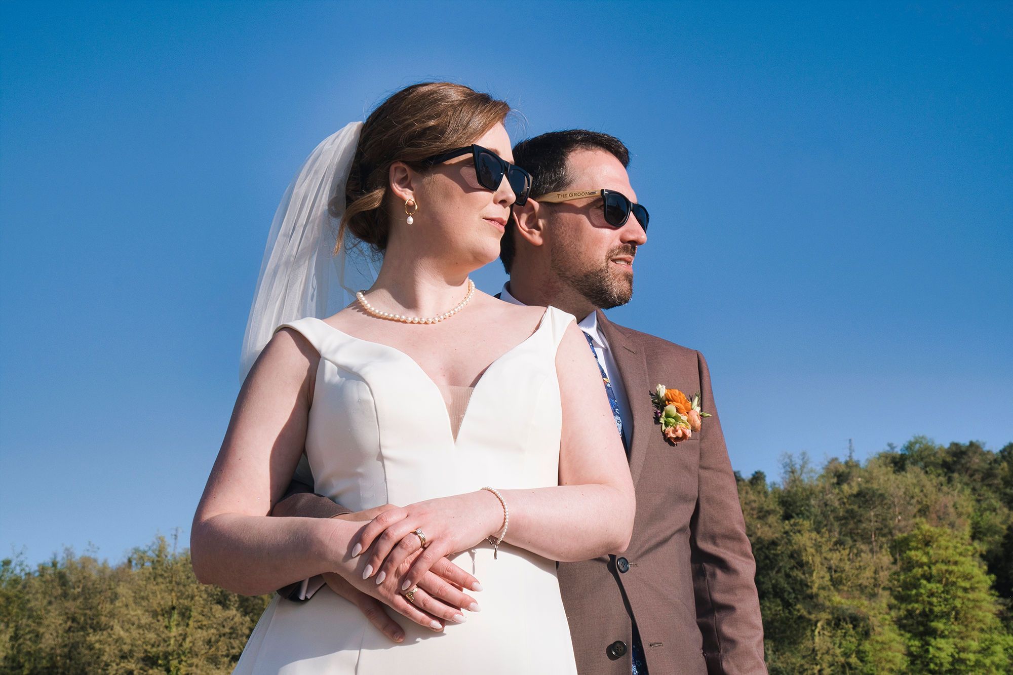 Bride and groom wearing sunglasses outdoors ceremony after of their destination wedding in Spain