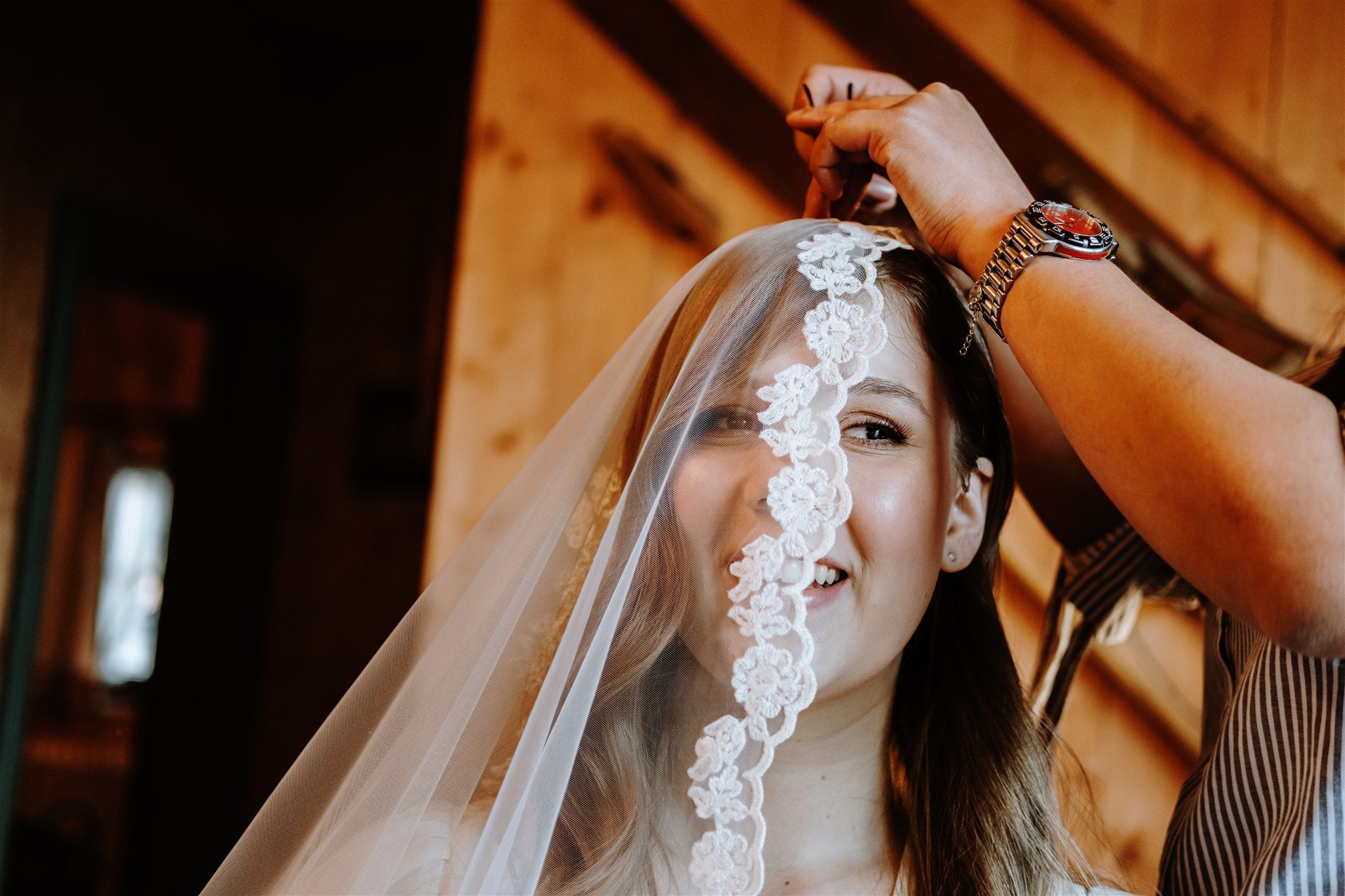 a bride having her veil pinned to her hair
