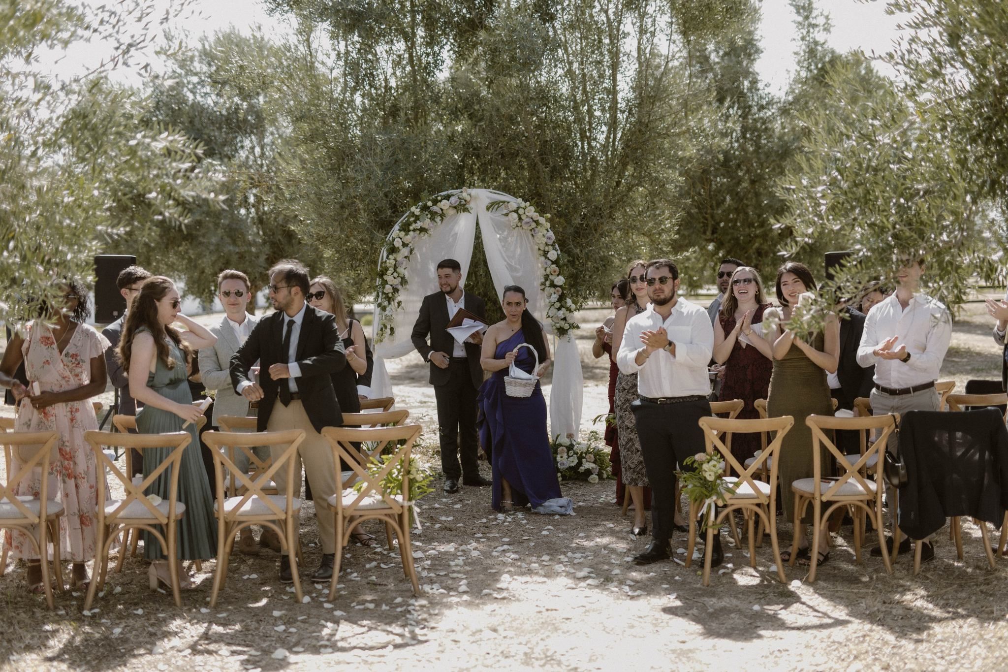 Guests of an intimate wedding in Portugal gathered in the ceremony area amidst a vineyard in Alentejo