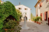 Bride and groom in the middle of an estate of a villa in Tuscany during their destination wedding in Italy