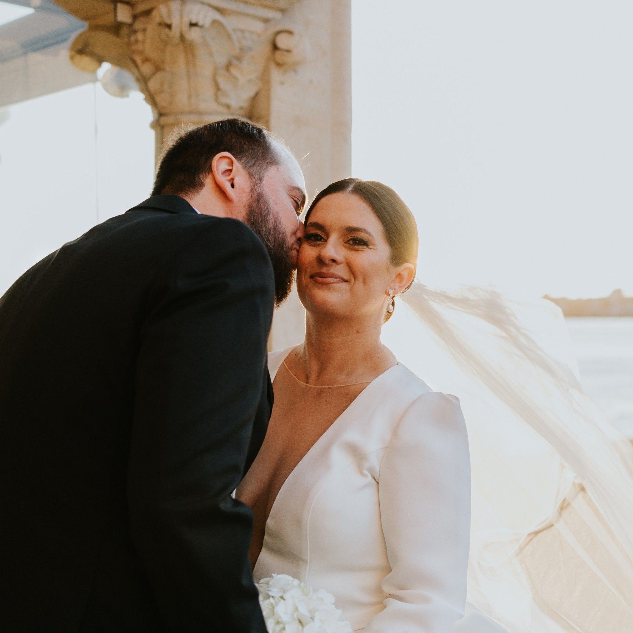 Groom kissing bride at a destination wedding in Portugal