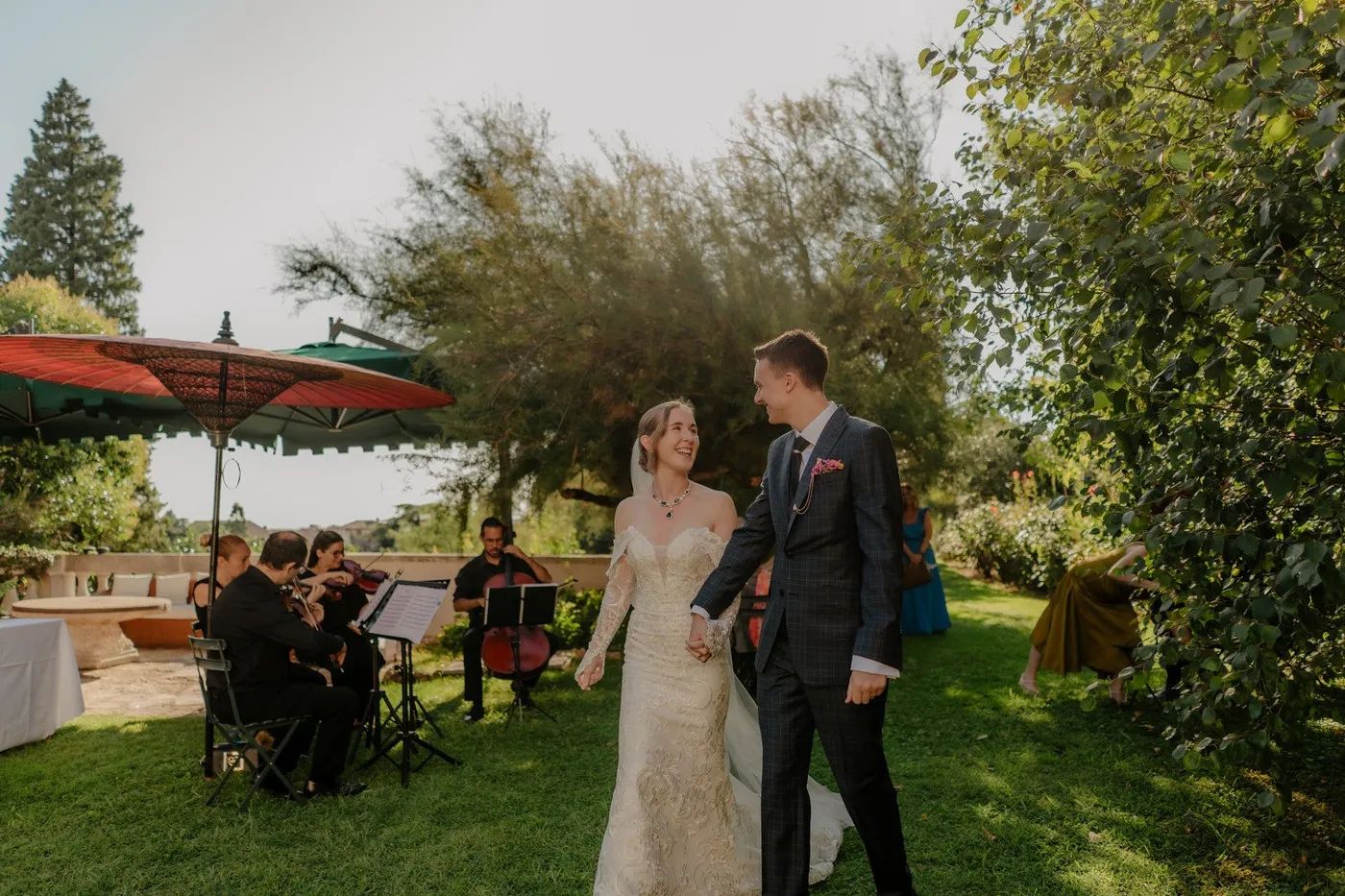 Newlyweds looking at each other during their destination wedding in Italy in a garden of a Tuscan villa