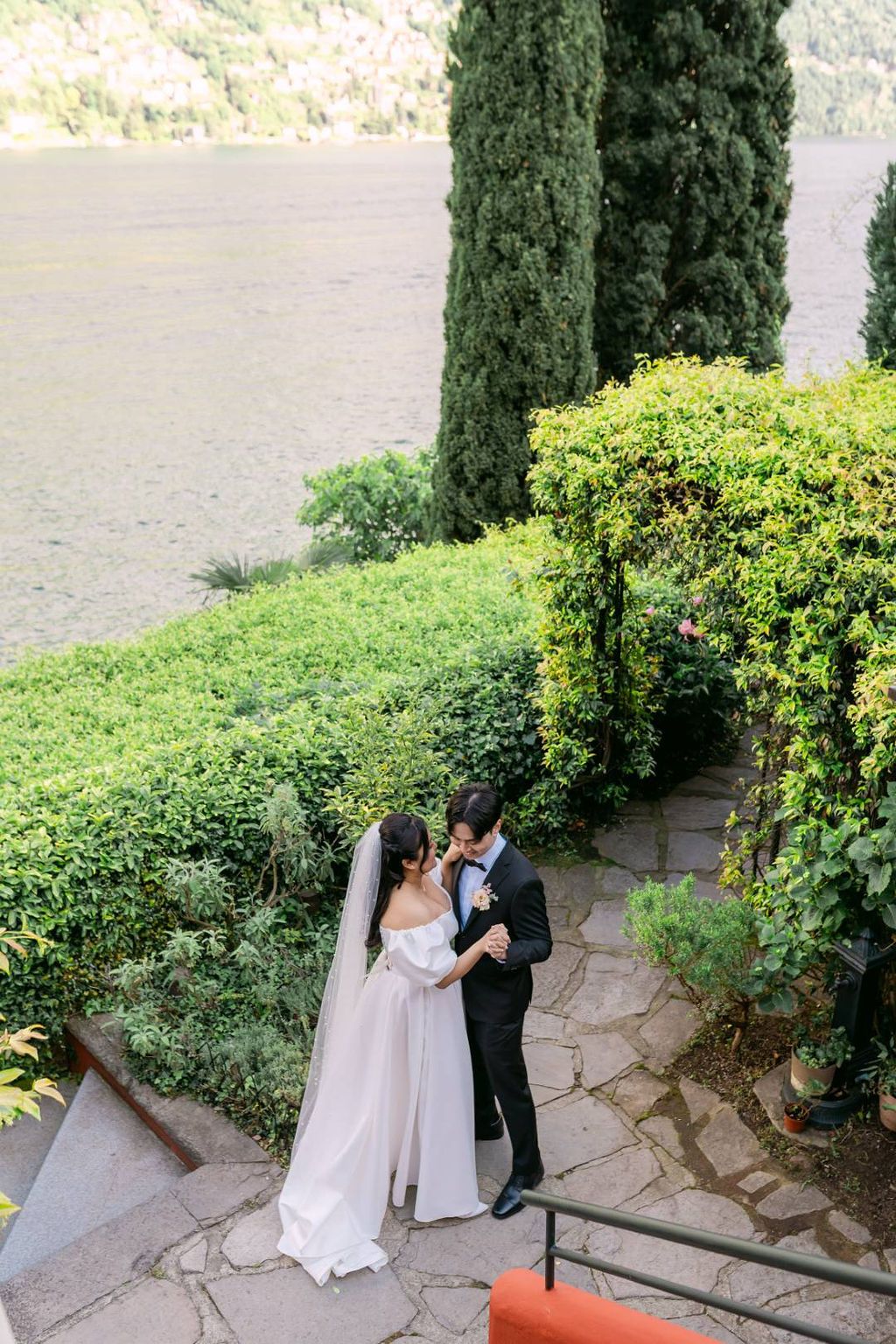 Bride and groom dance in the garden along Lake Como during their spring elopement in Italy