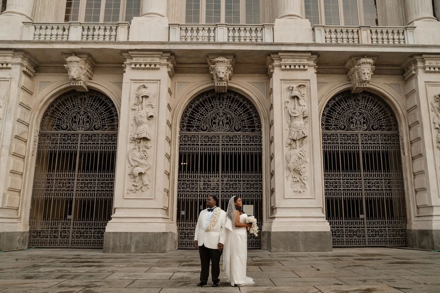 Newlyweds in front of a historic museum in Piedmont after their elopement ceremony in Italy