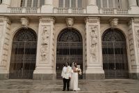Newlyweds in front of a historic museum in Piedmont after their elopement ceremony in Italy