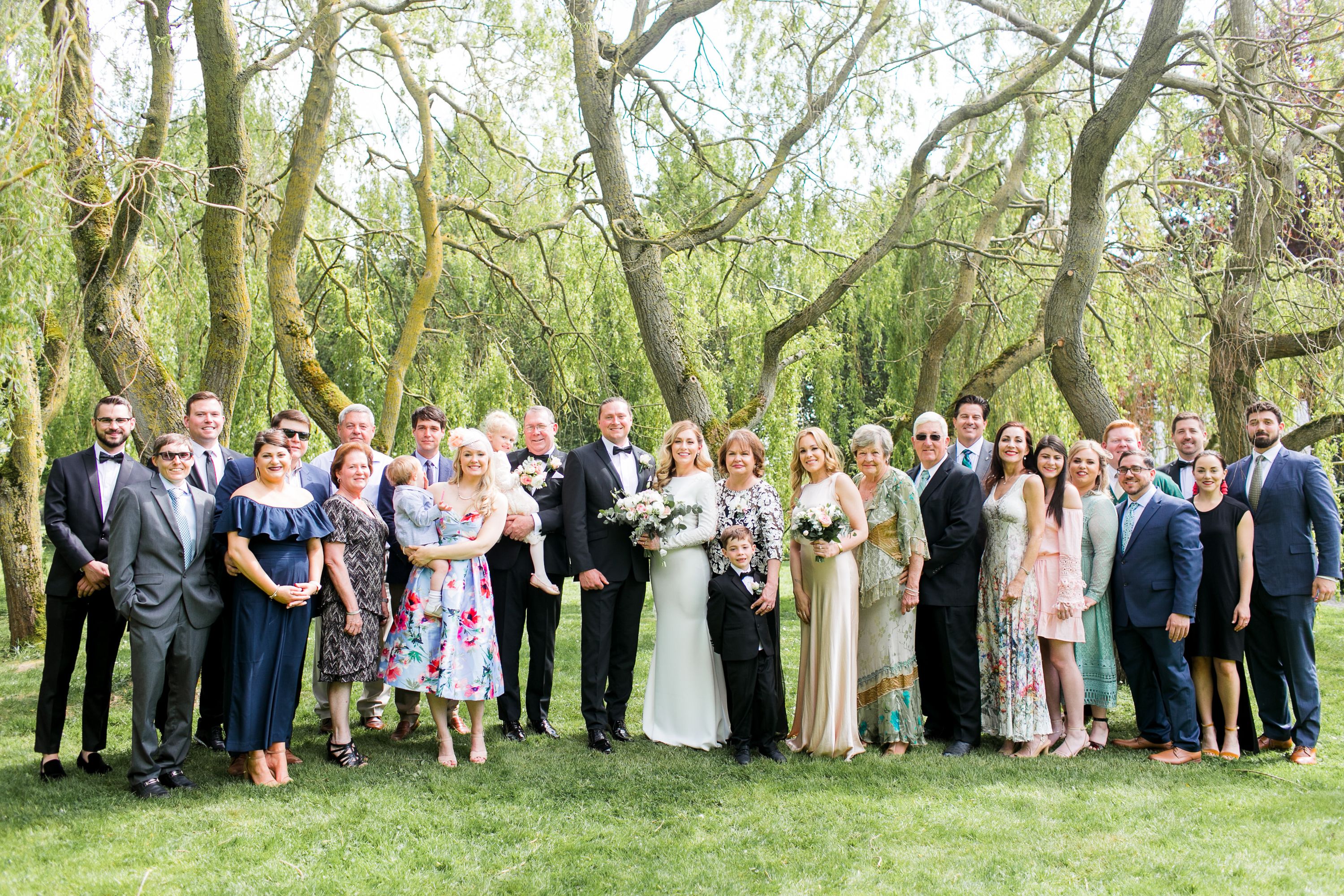 Bride and groom with family members posing for formal portraits at an intimate wedding in Europe