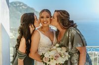 Mom and sister kiss bride as she gets ready for the ceremony of her elopement in Italy