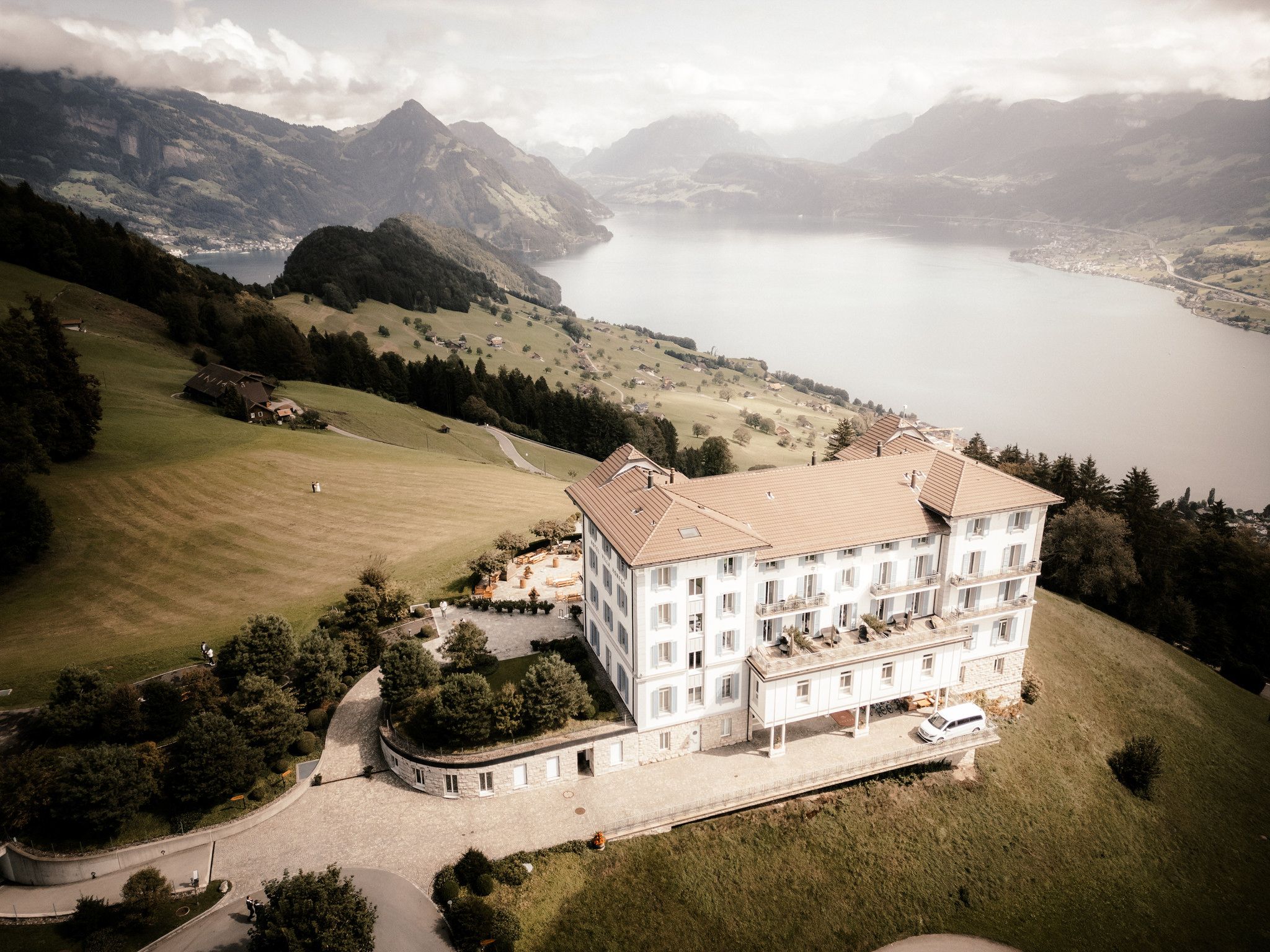 Mountaintop hotel with views of alps and lake in the background in Switzerland